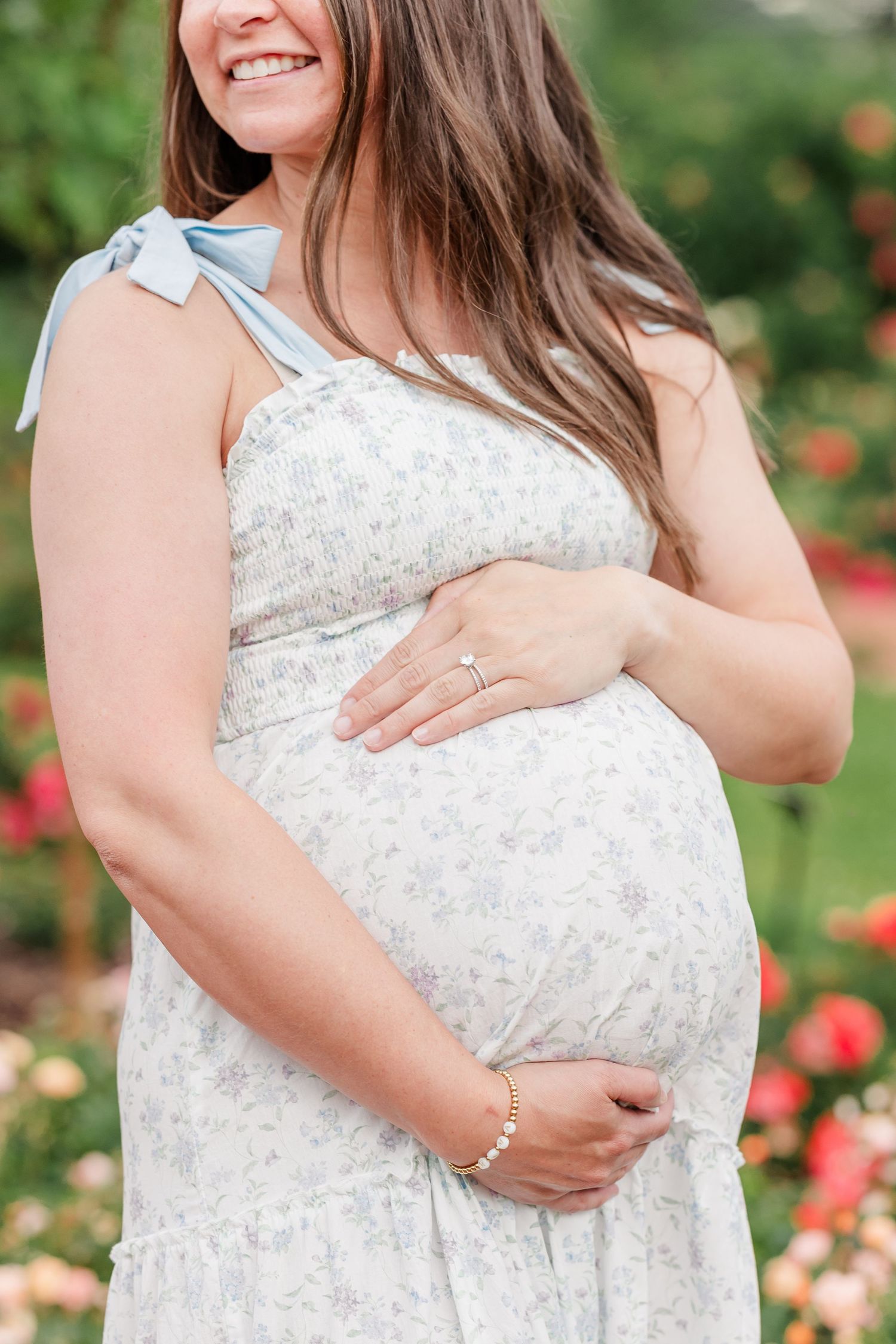 Close-up maternity portrait of an expecting mother holding her baby bump