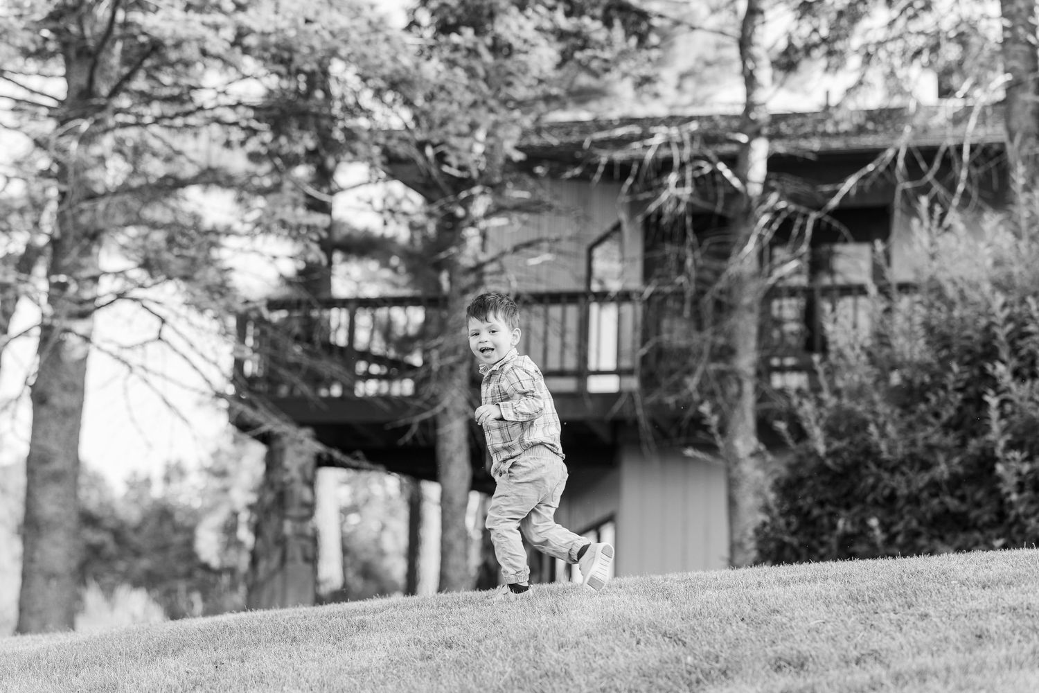 A black and white panoramic landscape photograph showing a view of trees and buildings under an overcast sky. Sorg family portraits at Shamr