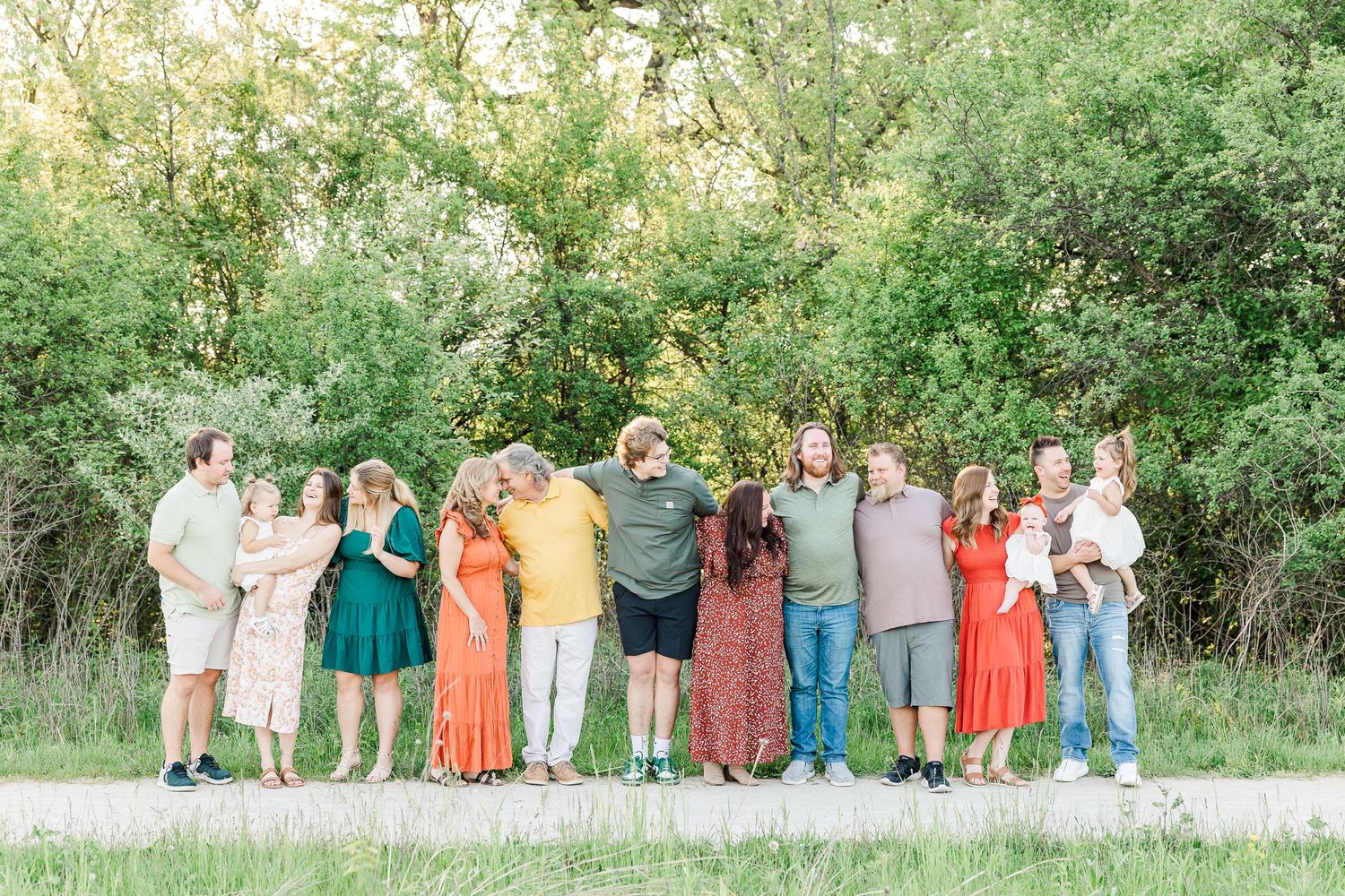 Large group poses together outdoors wearing colorful spring attire.