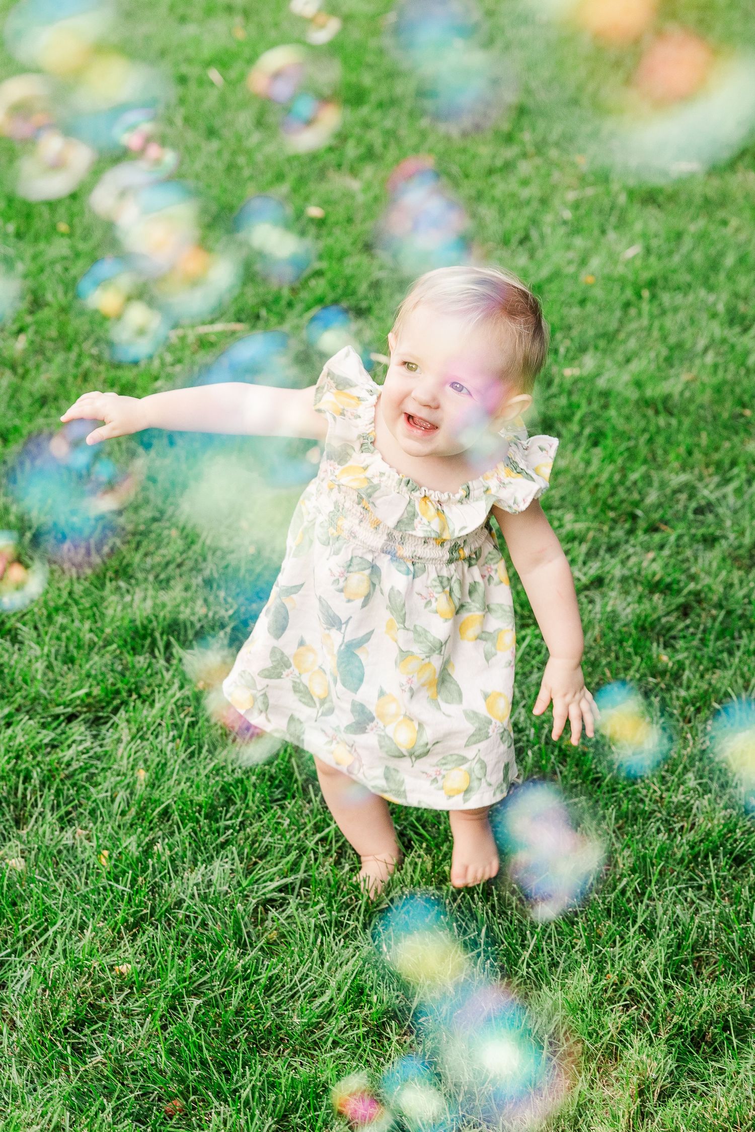 A magical moment with floating bubbles in a lush garden setting.