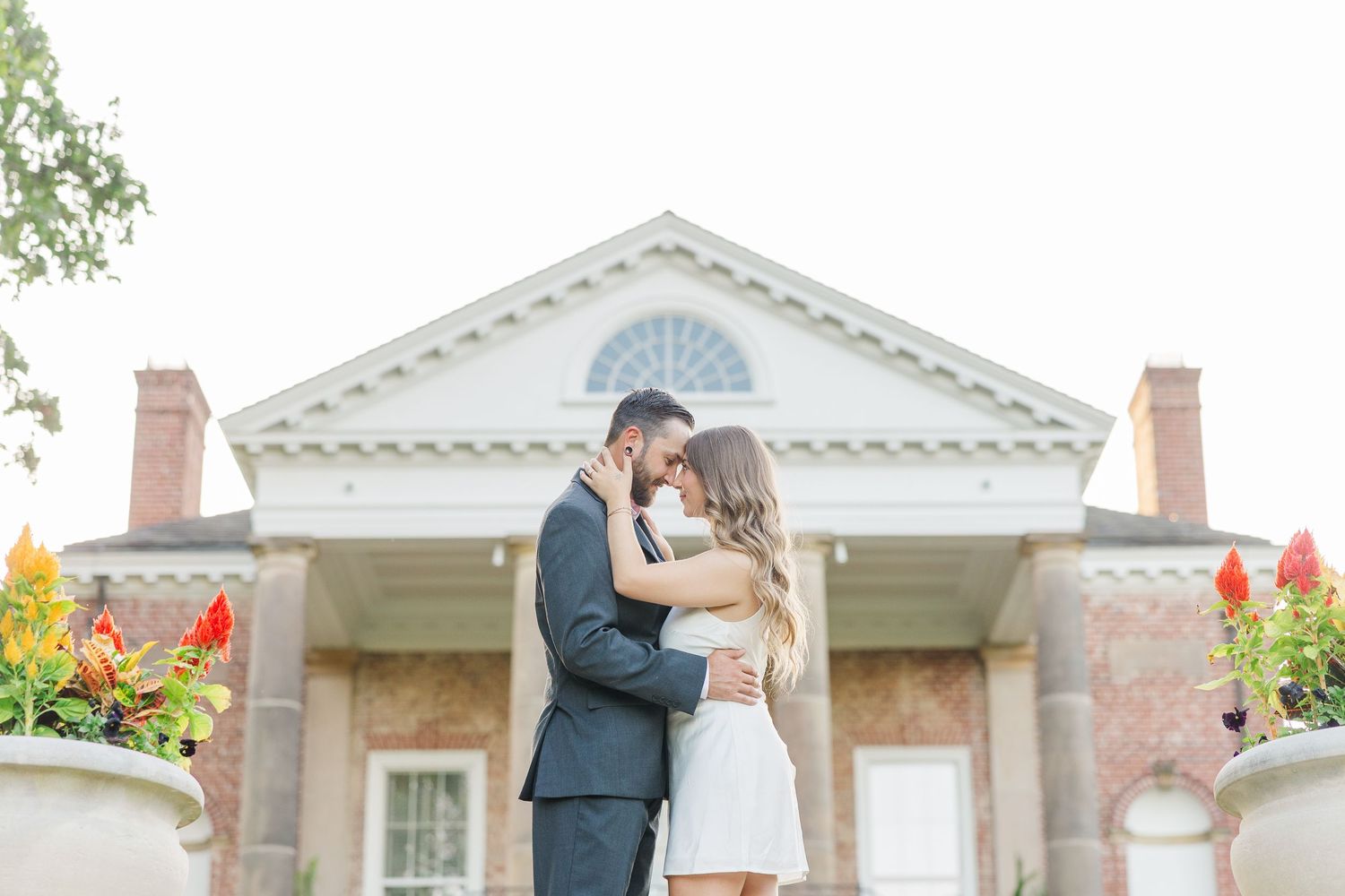 Couple embracing outside mansion during engagement photos at Cantigny Park