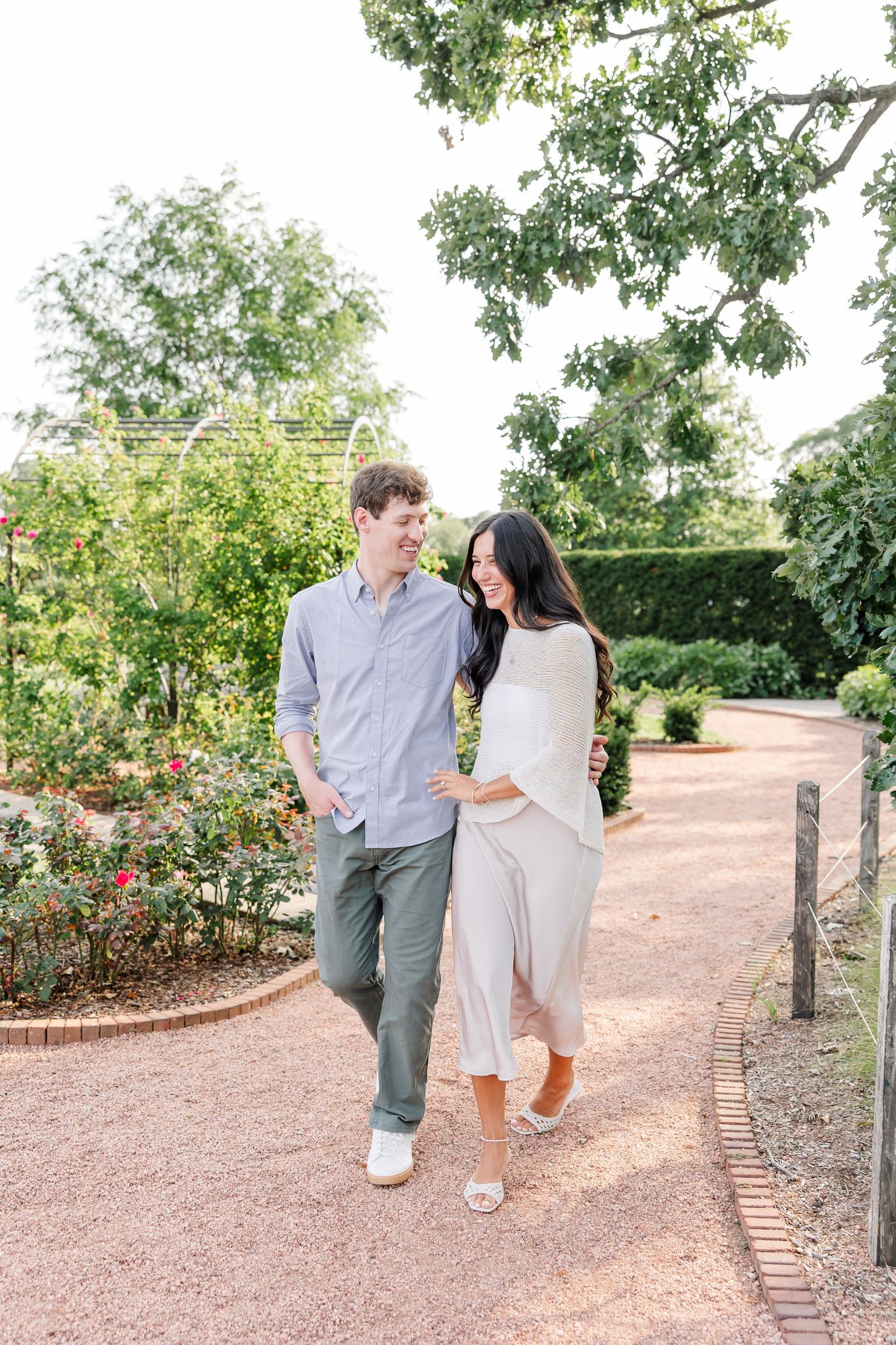 Newly engaged Alysia and Jack walk together through the colorful Cantigny Park gardens.