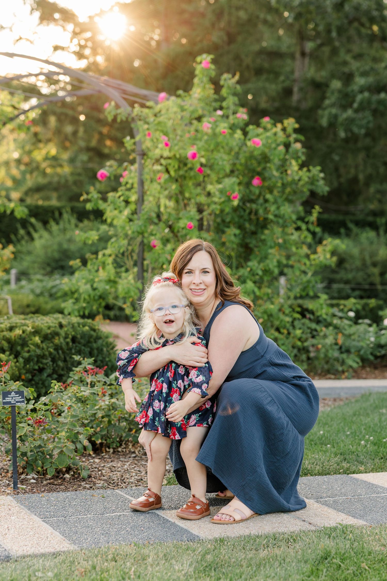 Hilary crouching beside Caroline for a sweet mother-daughter portrait in the Cantigny Park gardens.