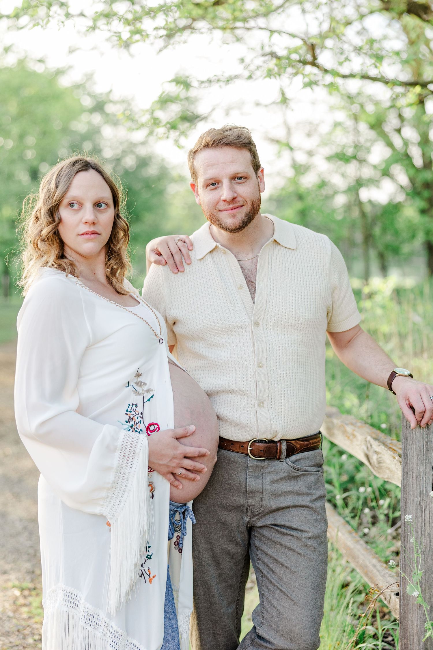 Expecting parents standing together during golden hour maternity photos at Veterans Acres in Crystal Lake.
