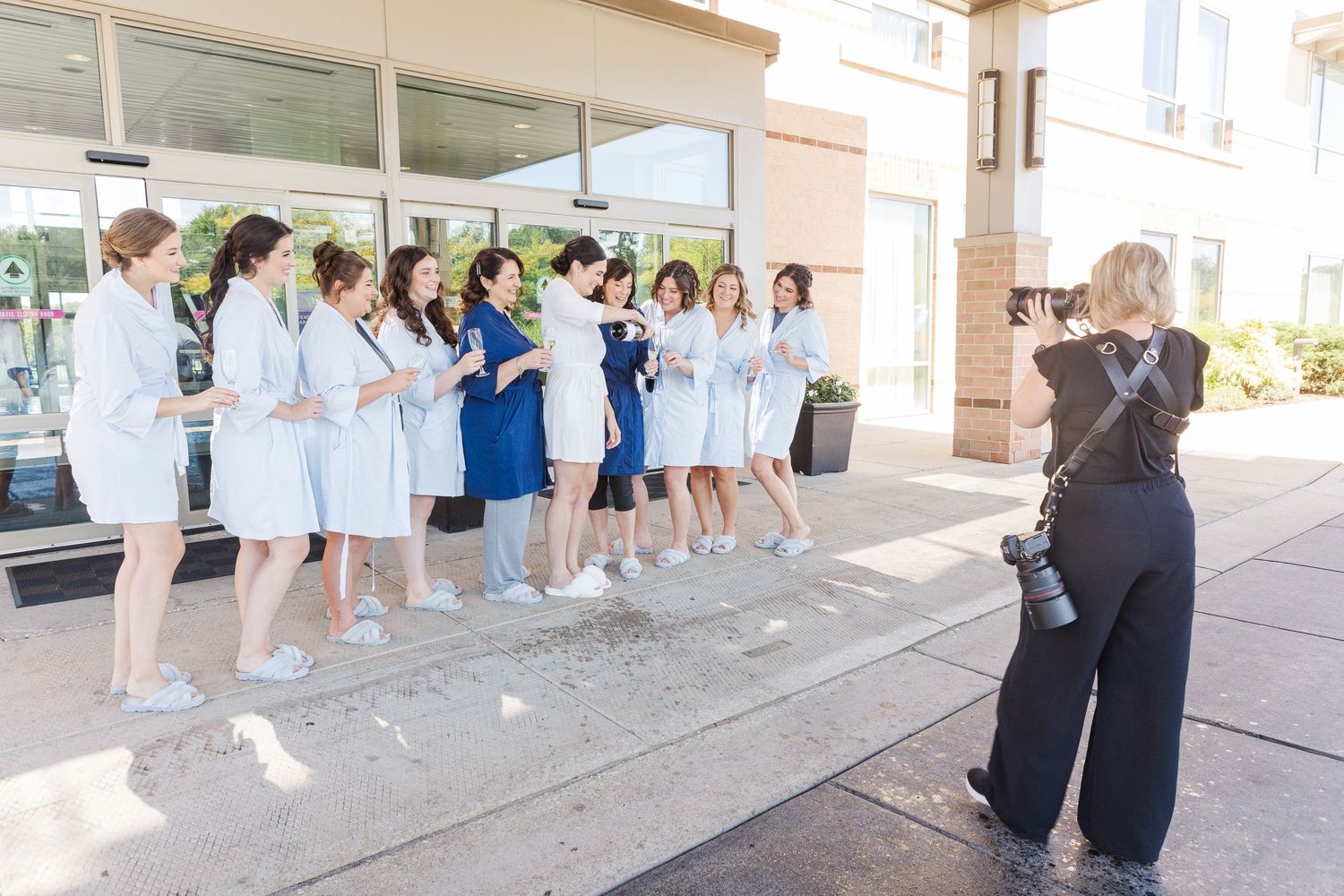 Cassie Lacina photographing a wedding party outdoors before the ceremony