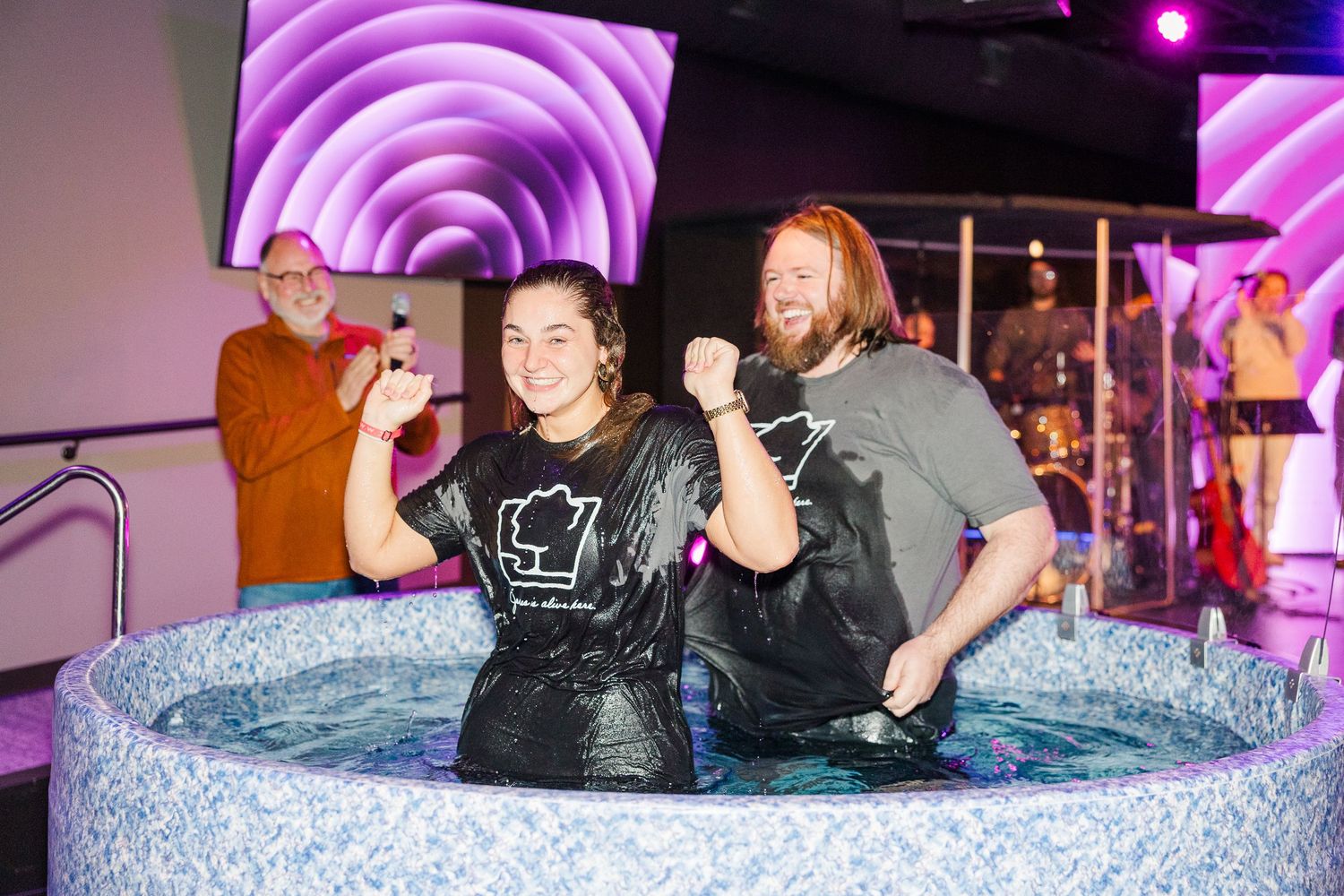 People celebrating during a baptism service at The Chapel in McHenry