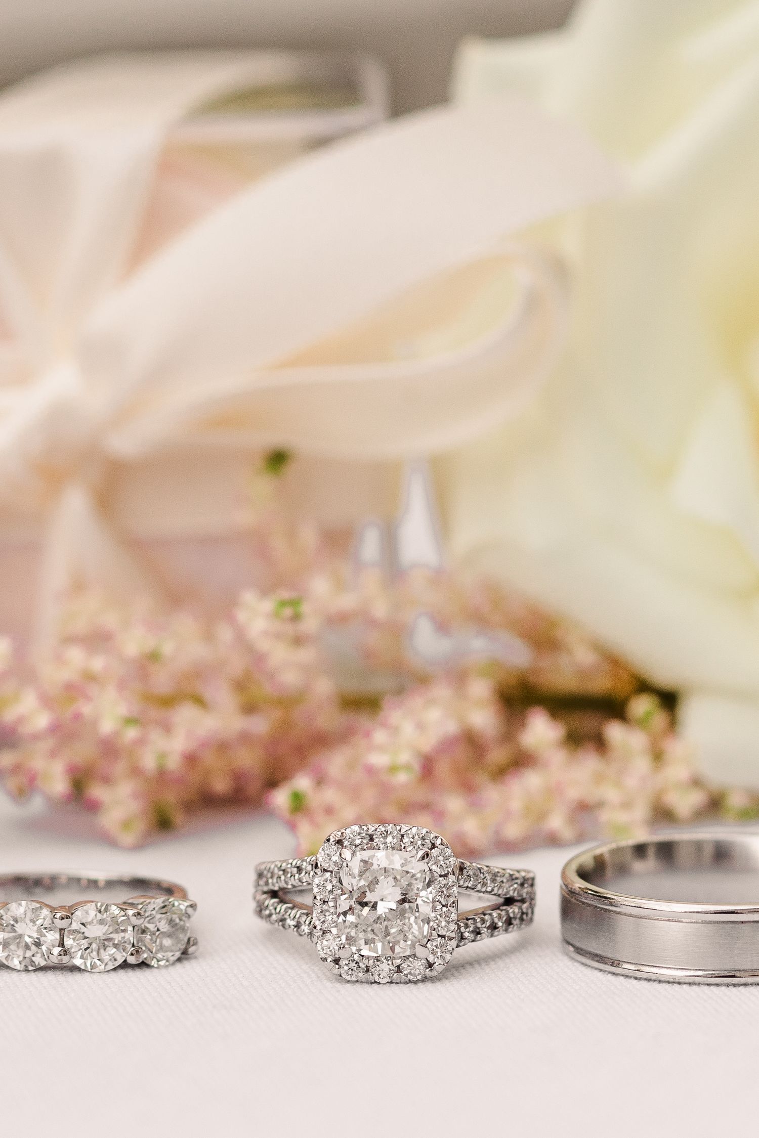 Wedding ring set with diamond details arranged with delicate pink flowers.