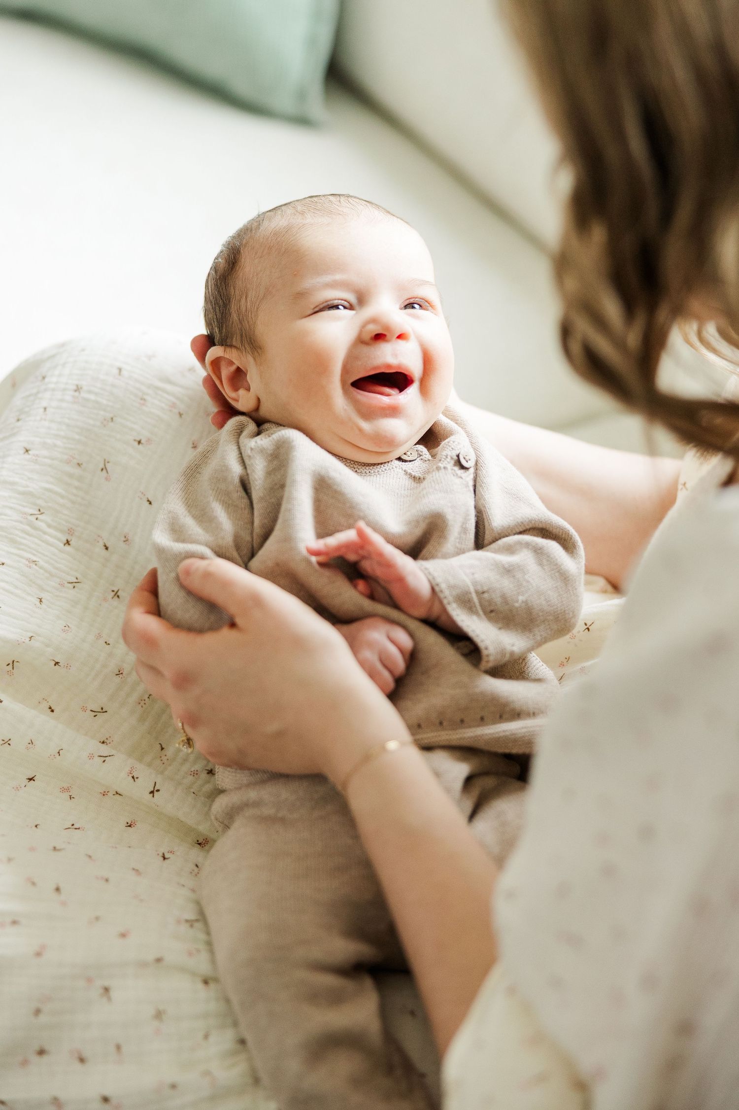 Palatine IL lifestyle newborn photography of a smiling baby during a natural in-home newborn session with parents