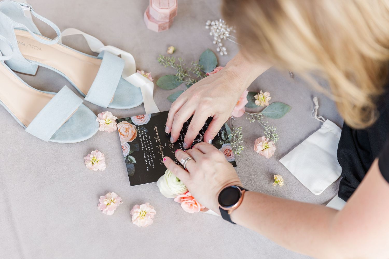 Cassie Lacina styling wedding details including shoes, jewelry, and florals