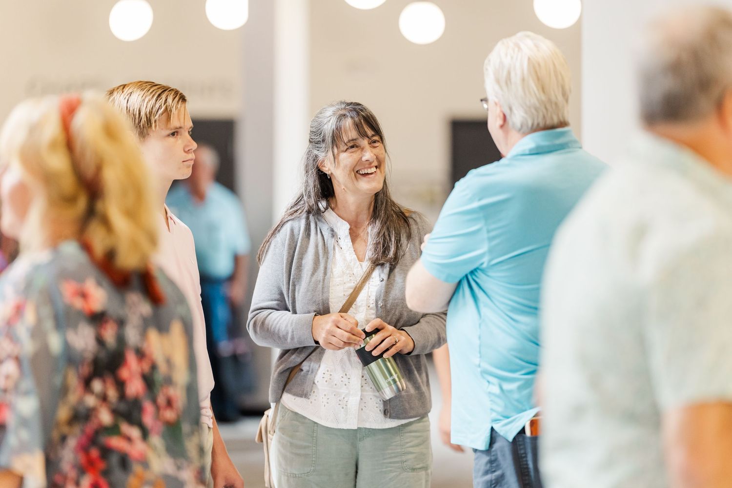 Woman talking with attendees during a church event at The Chapel in McHenry.