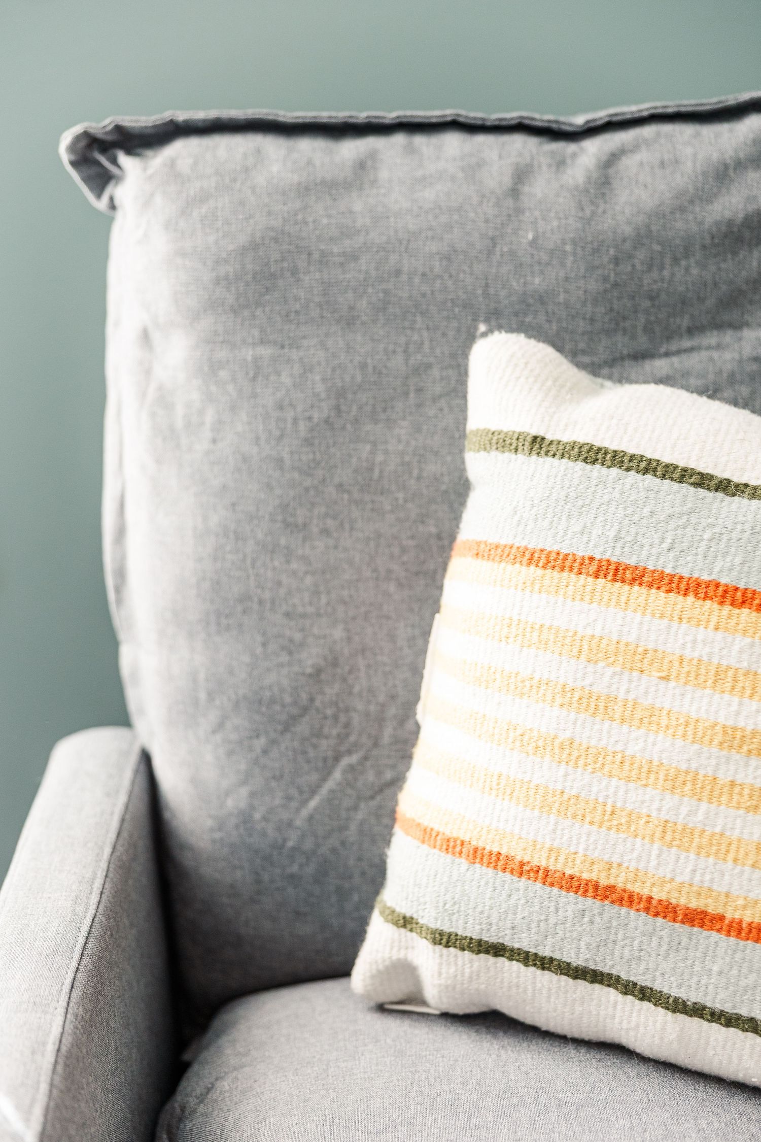 Nursery chair and pillow detail from a cozy in-home maternity session in Crystal Lake, Illinois.