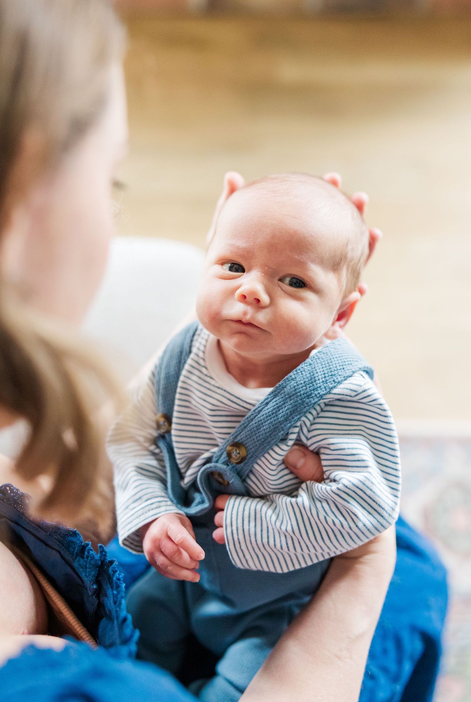 Newborn baby boy looking up during bright in-home lifestyle newborn session in Crystal Lake, Illinois