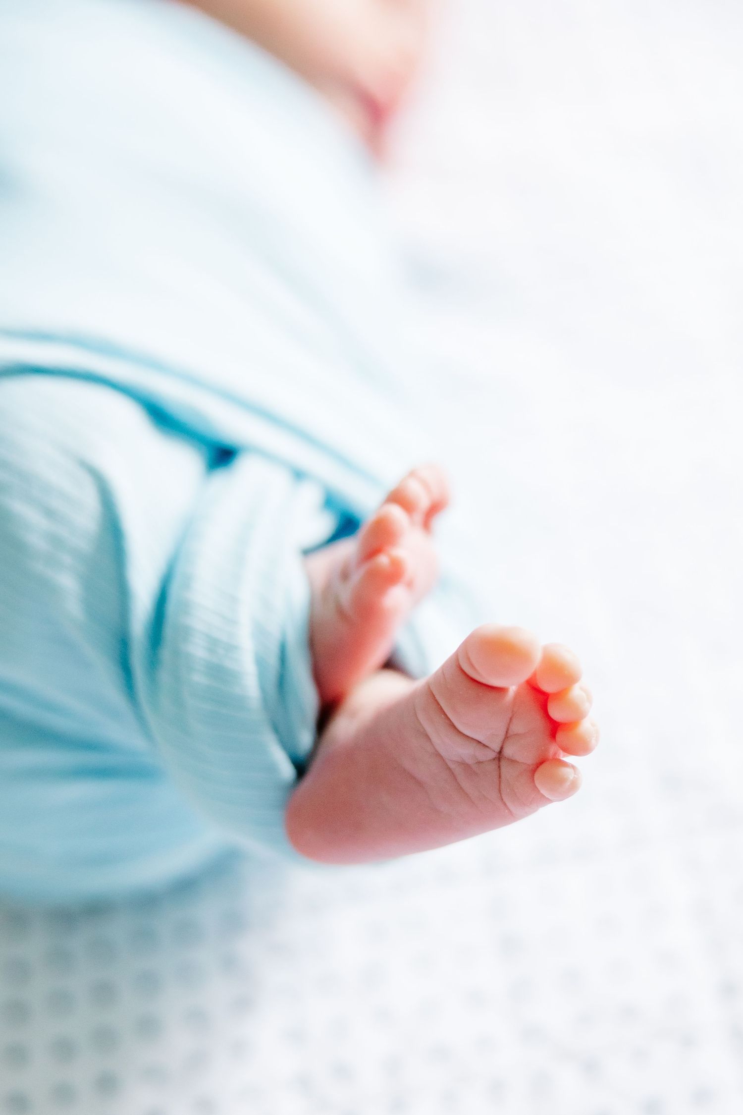 Close-up of newborn feet during bright in-home lifestyle newborn session in Crystal Lake, Illinois