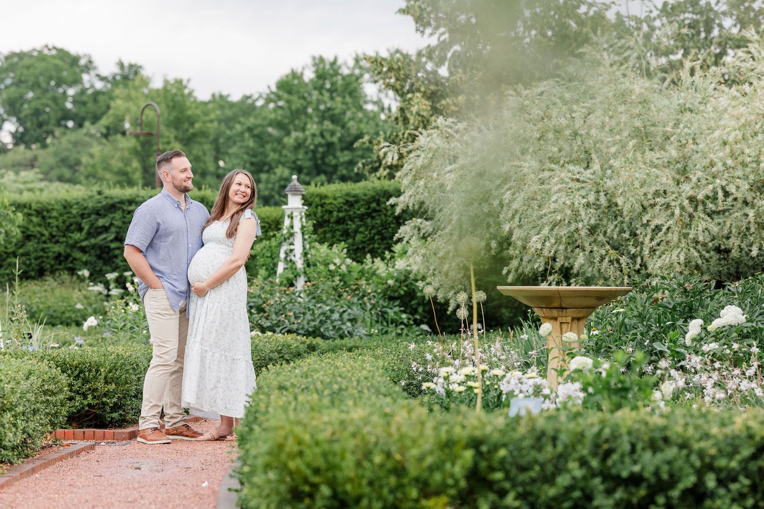 Expecting parents standing together in a quiet garden during a Wheaton maternity session