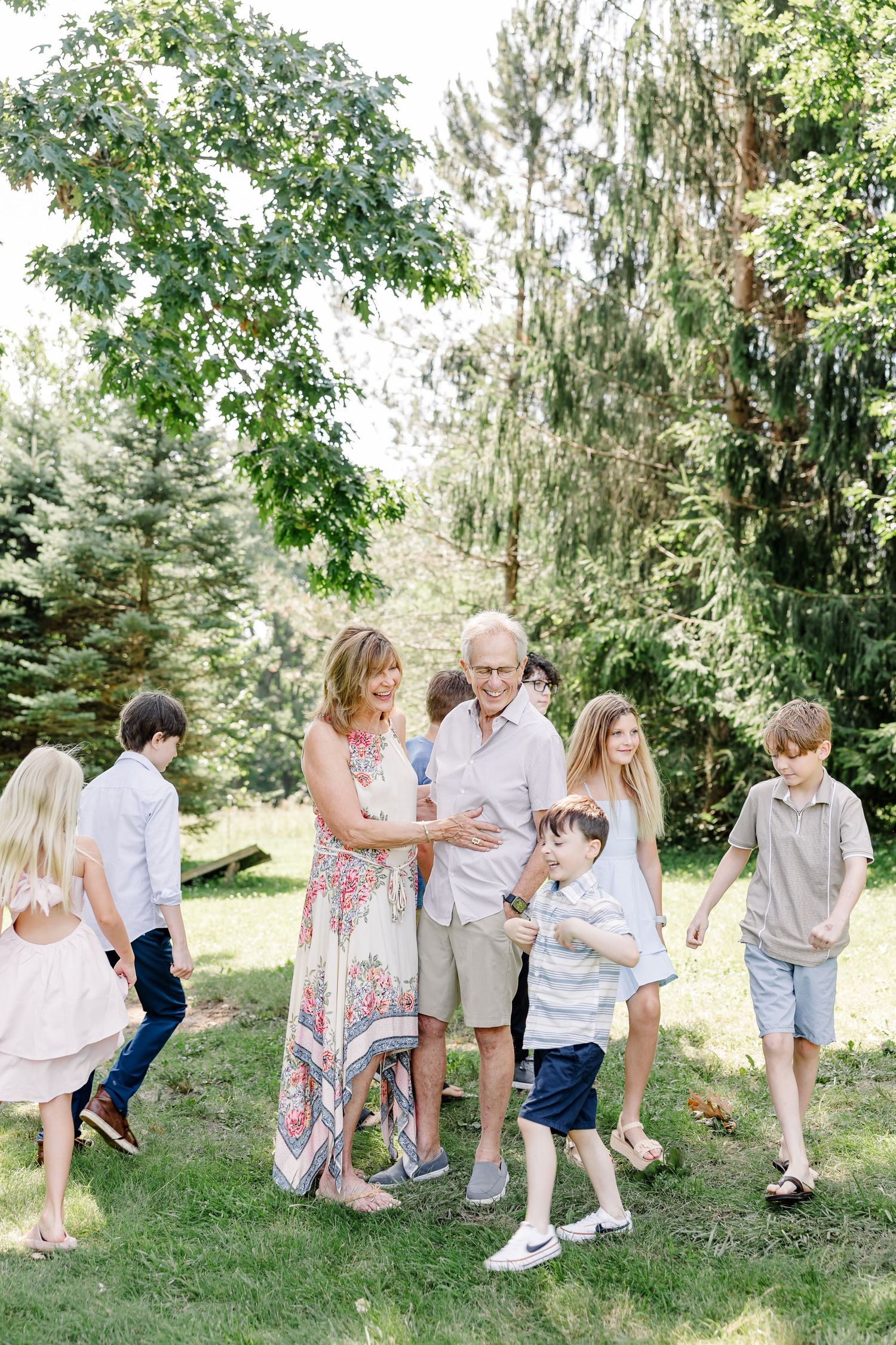 Grandparents surrounded by grandchildren during a summer family reunion photo session in Crystal Lake, IL.