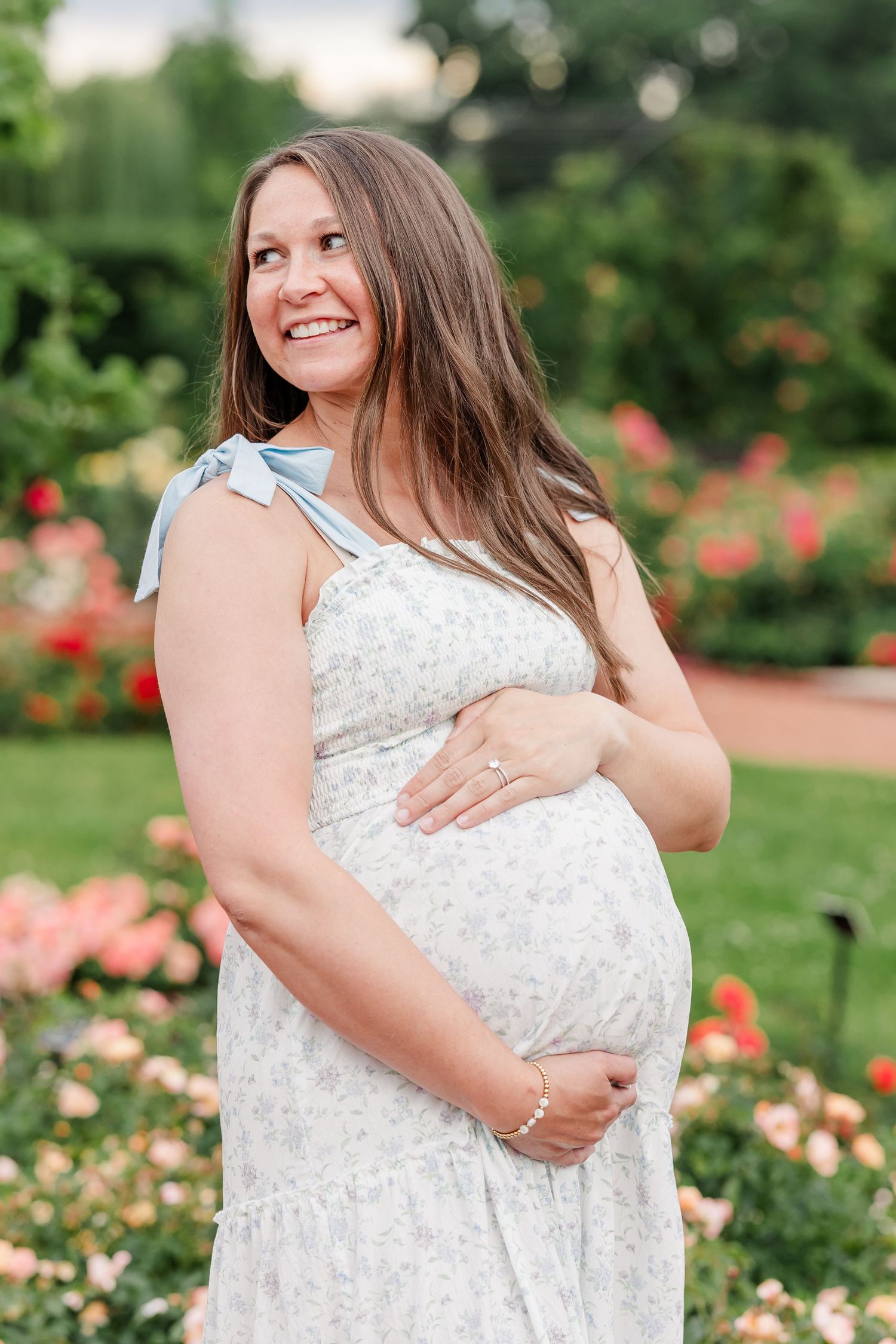 Expecting mother smiling in the rose garden during her Cantigny Park maternity photos