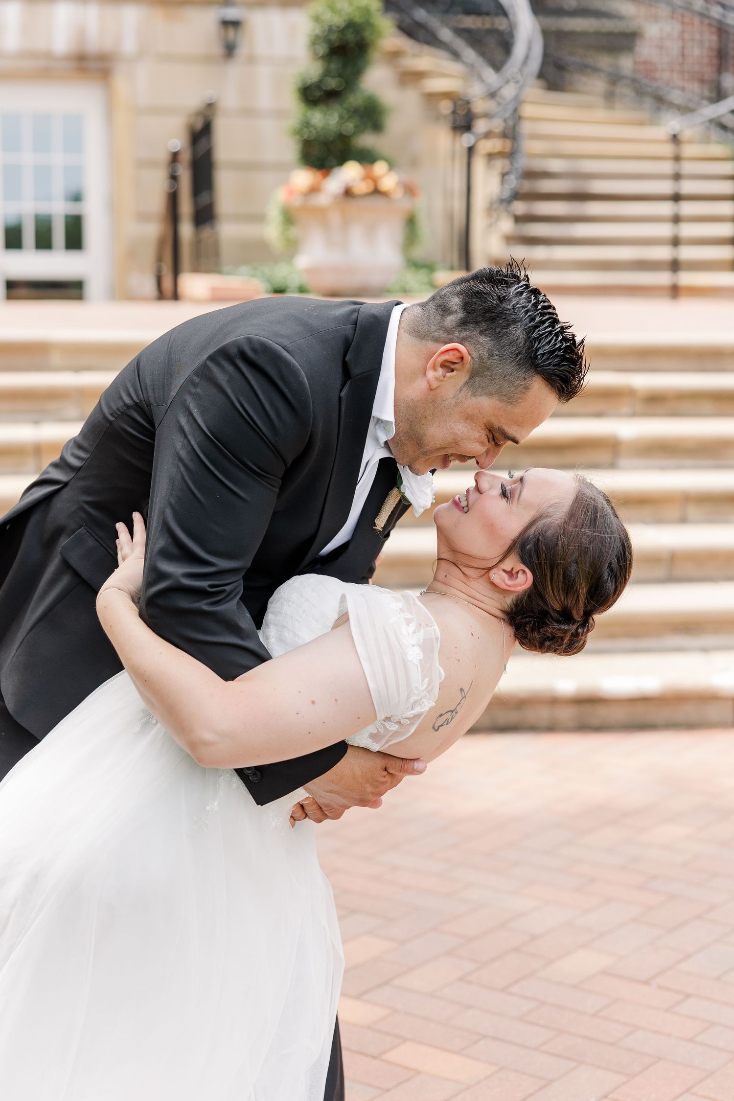 Rafael dipping Monika for a romantic newlywed portrait in front of the McCormick House steps.