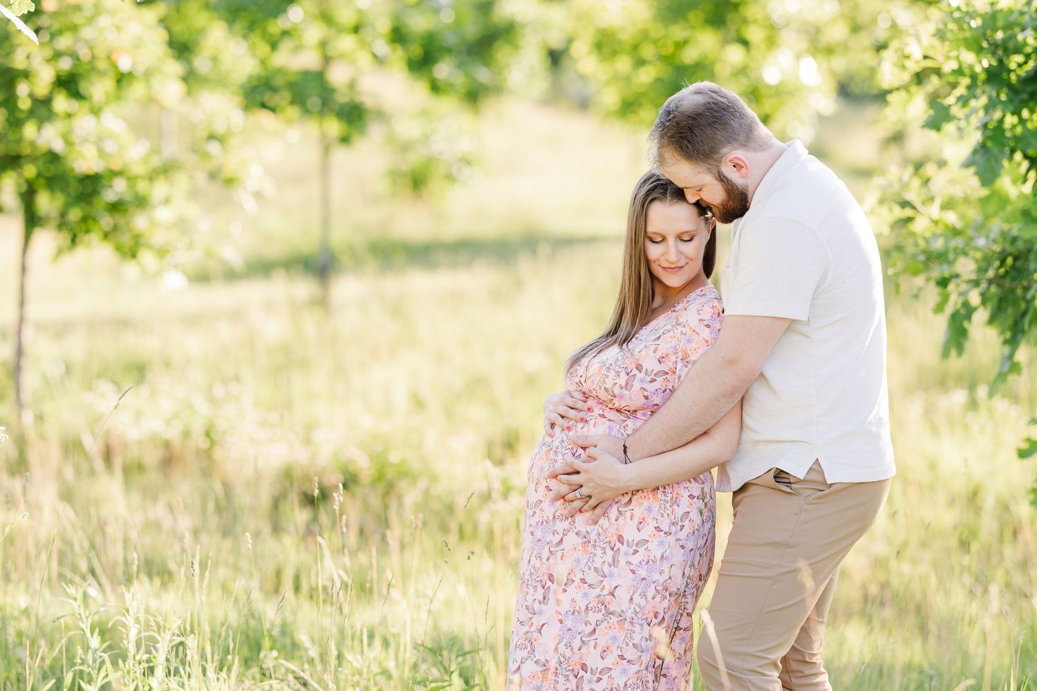 Glowy summer maternity photo of expecting parents in the meadow at Cantigny Park in Wheaton Illinois
