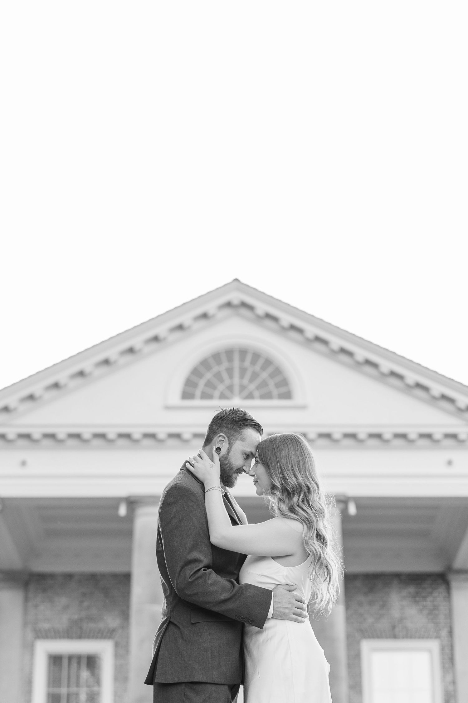 Black and white couple portrait outside mansion during engagement photos at Cantigny Park