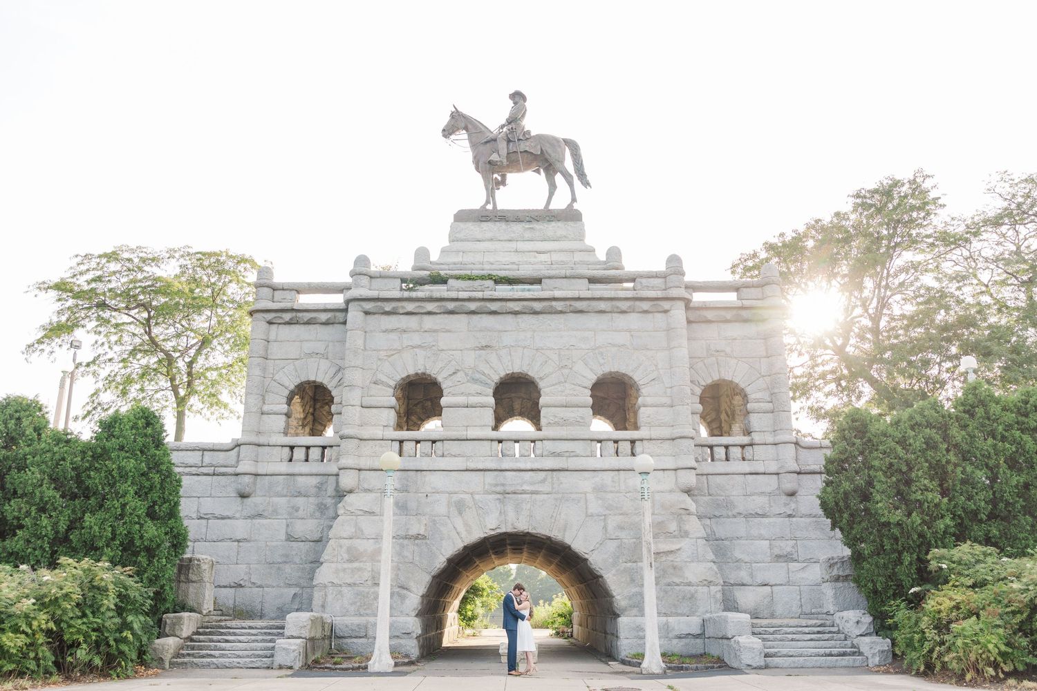 Elizabeth and Joe embracing under the Ulysses S. Grant Monument in Lincoln Park, Chicago