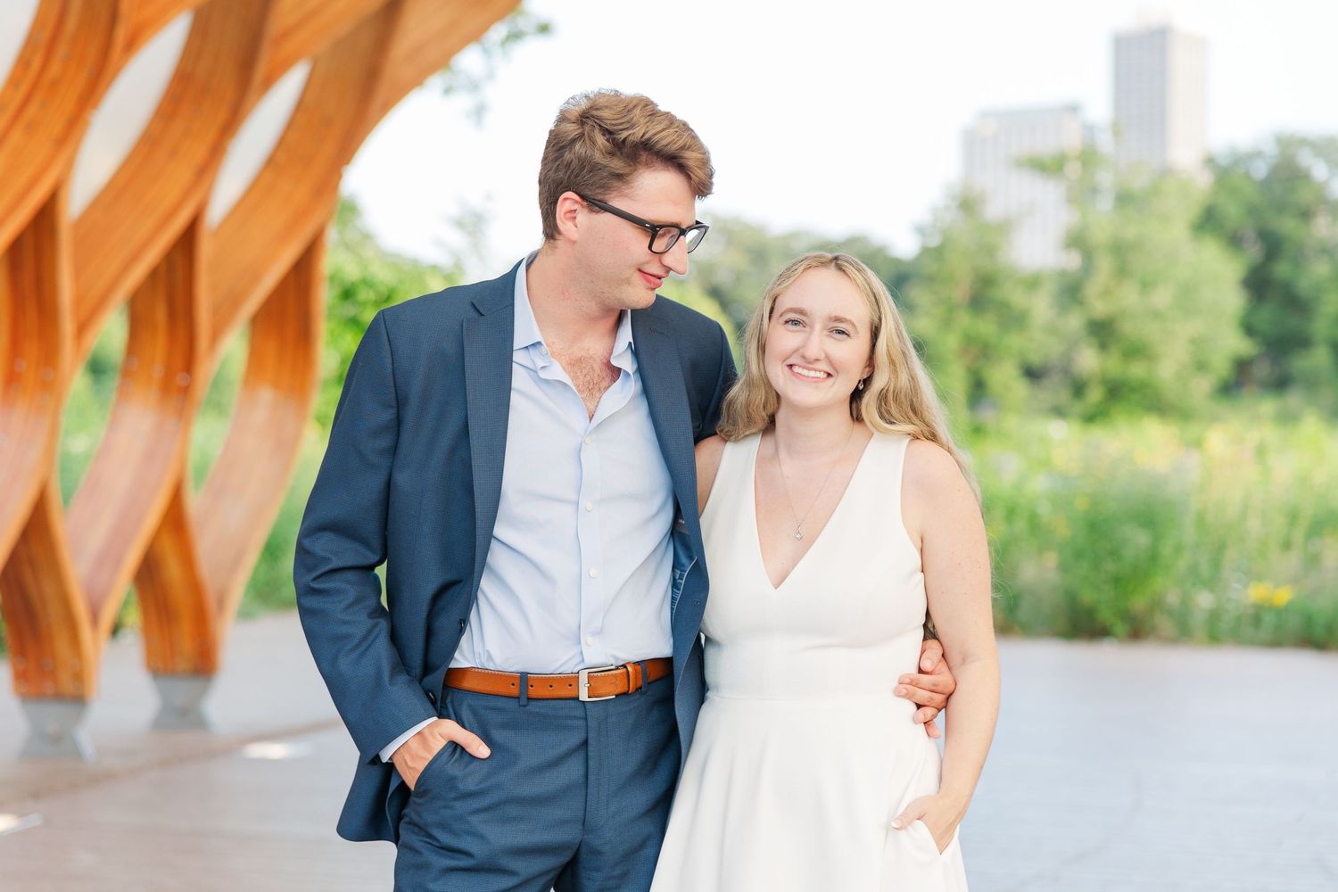 Elizabeth and Joe standing under the Honeycomb Pavilion in Lincoln Park, Chicago, smiling at the camera