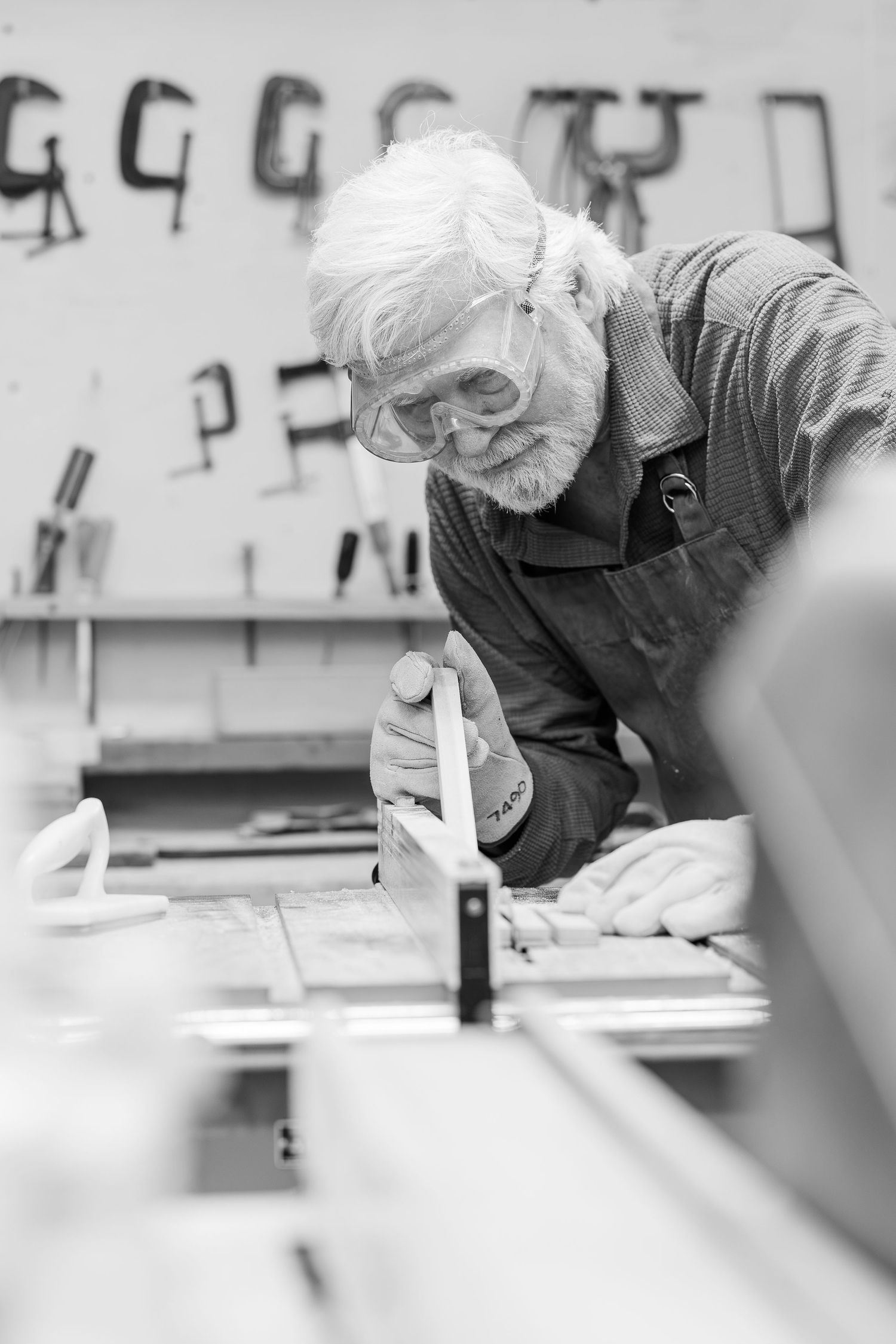 Black and white Beacon Hill senior living branding photo in Lombard, Illinois featuring resident woodworking