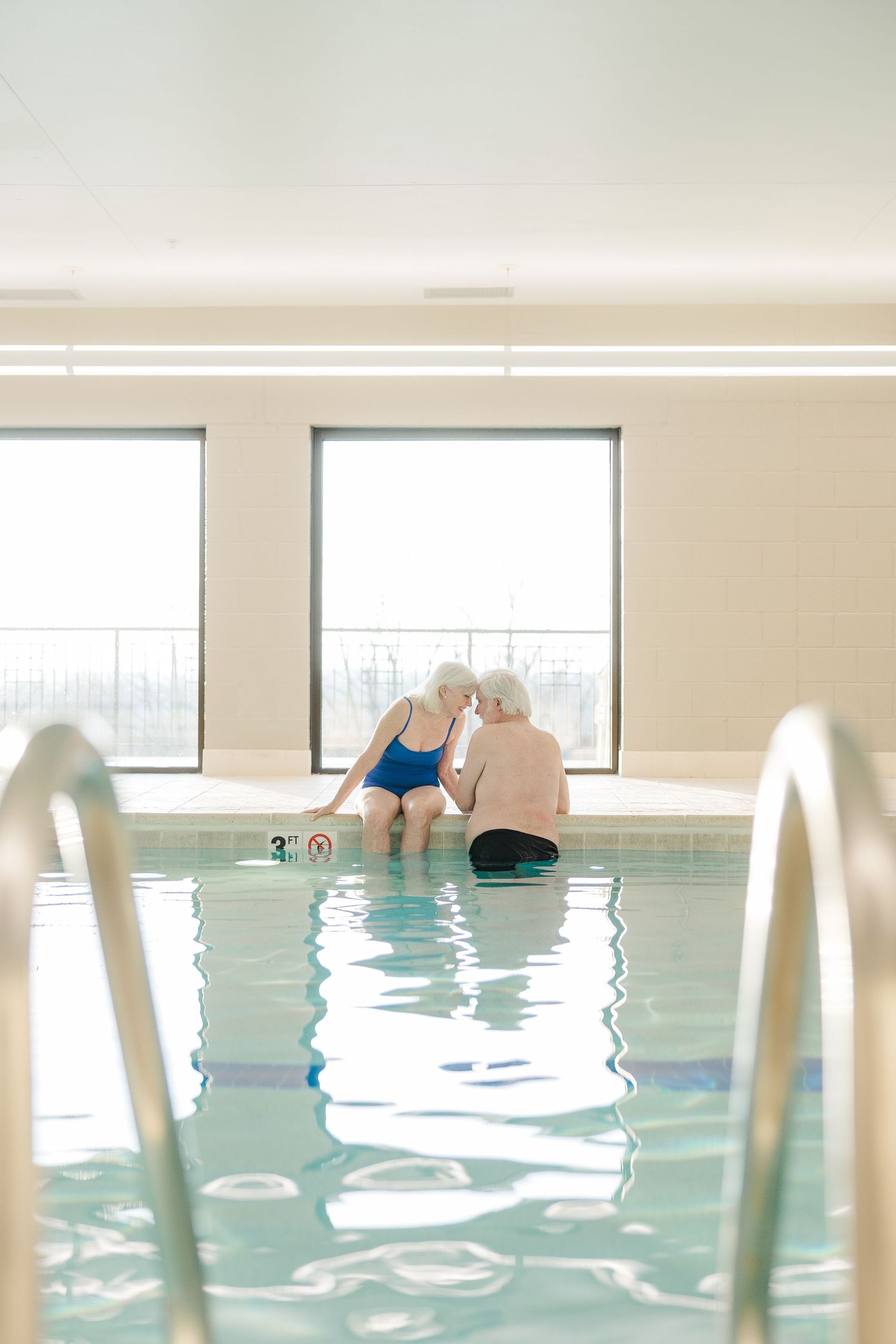Beacon Hill senior living branding photo in Lombard, Illinois featuring resident exercising in indoor pool