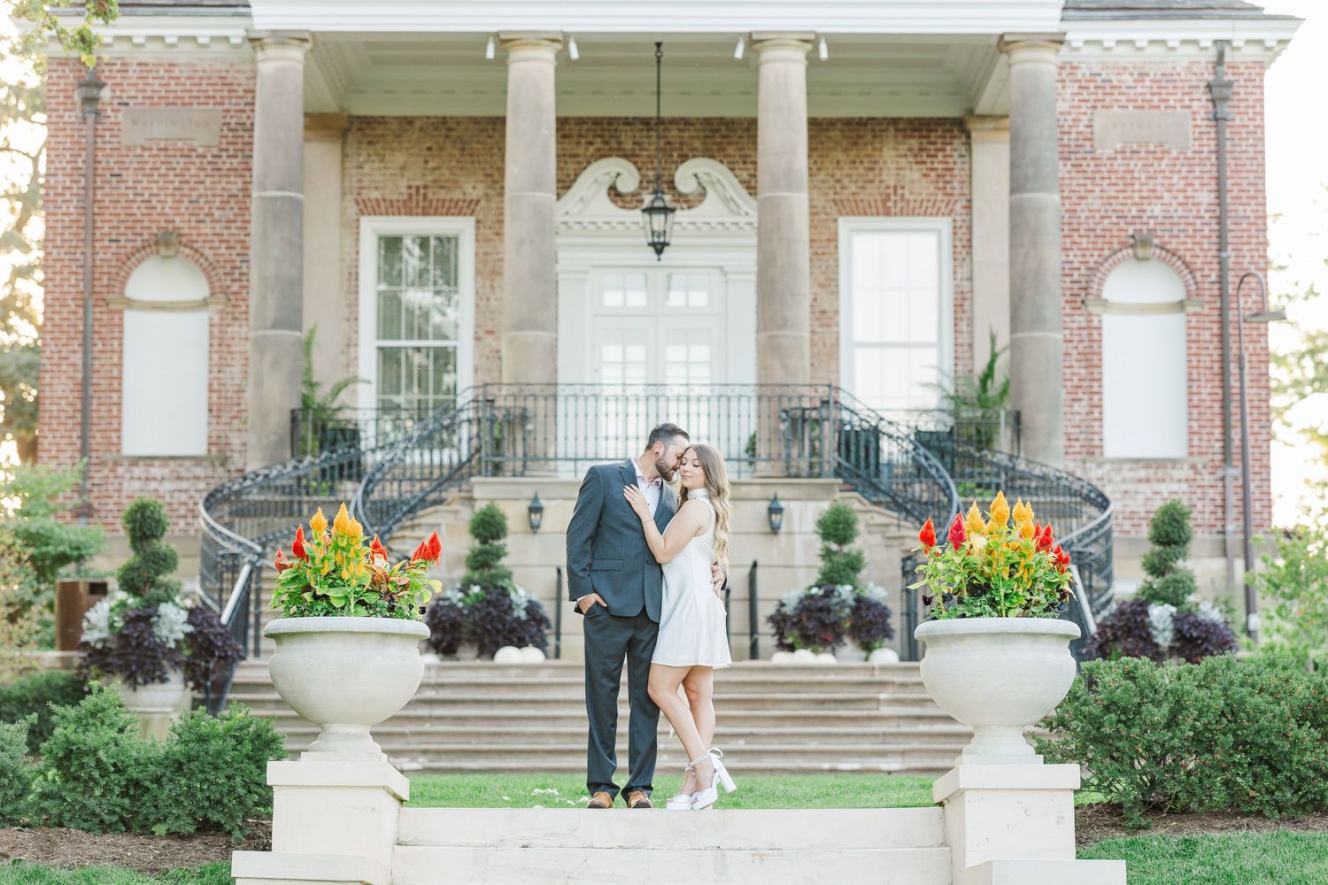 Couple standing together outside mansion during engagement photos at Cantigny Park
