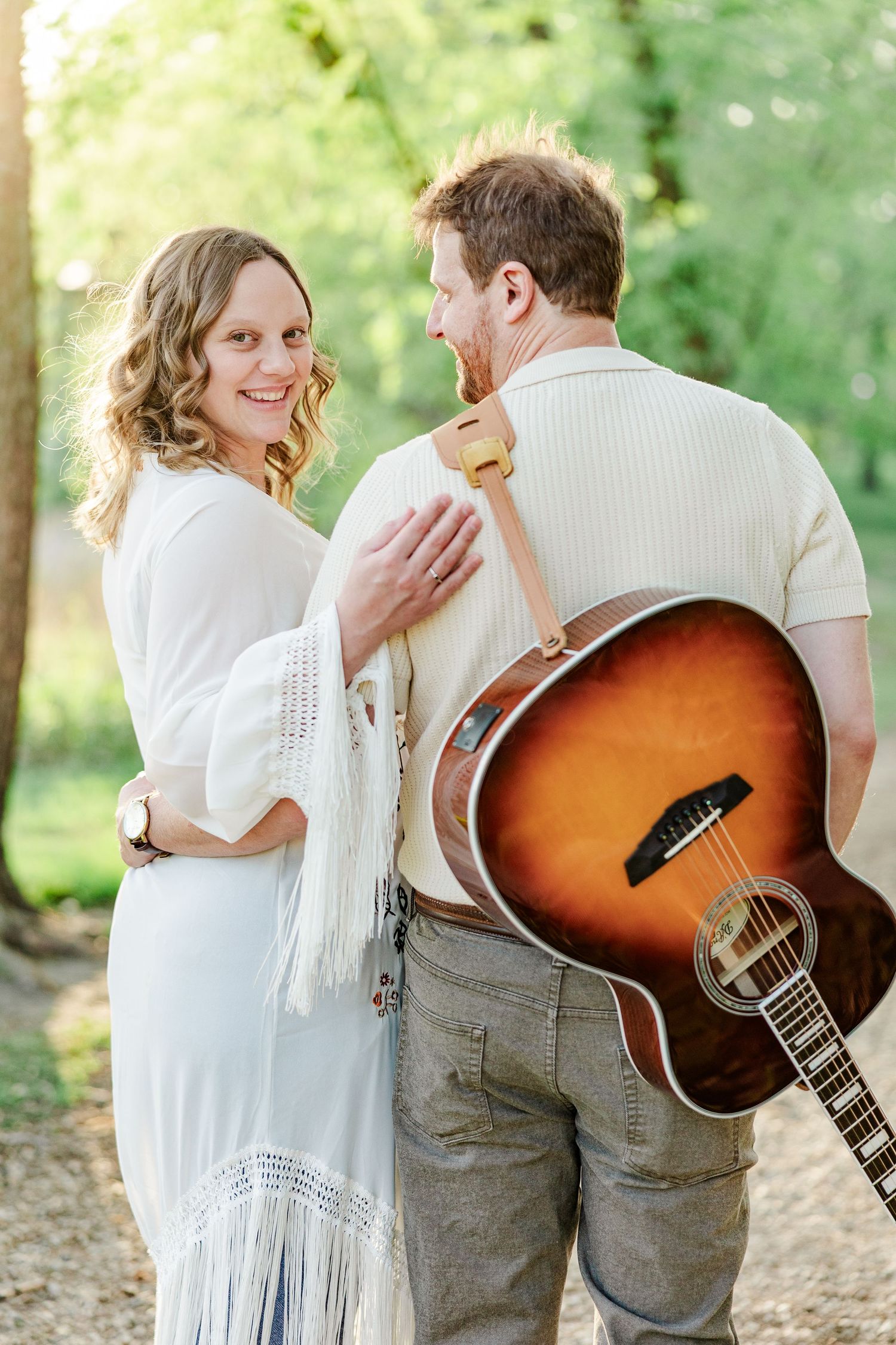 Music-inspired maternity portrait with guitar during golden hour at Veterans Acres in Crystal Lake.