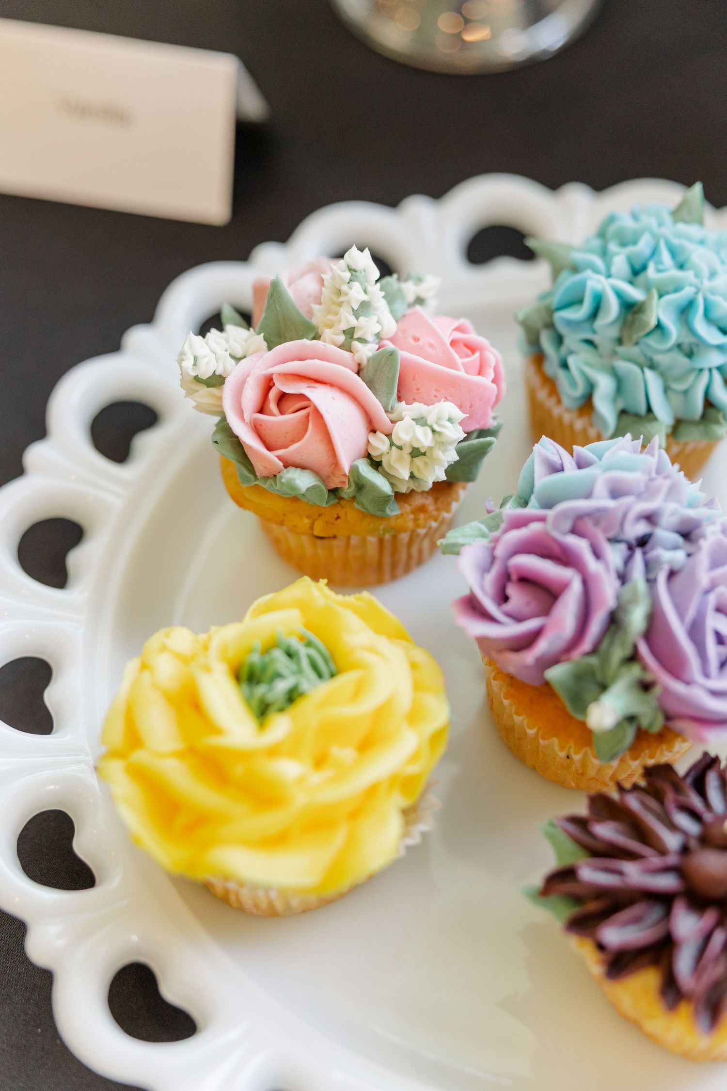 Pastel wildflower cupcakes with buttercream blooms at bridal shower