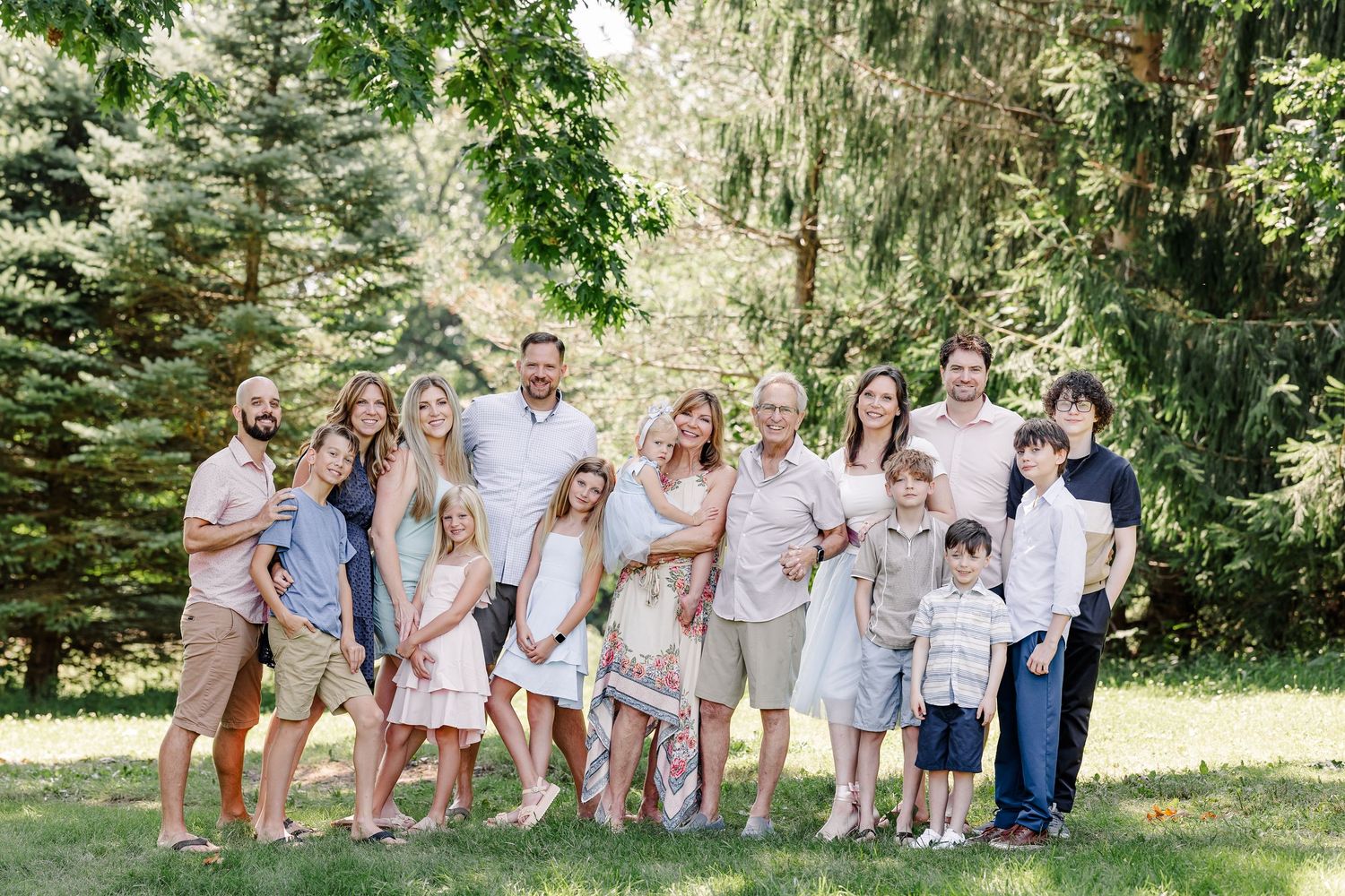 Large extended family portrait during a summer family reunion session in Crystal Lake, Illinois.