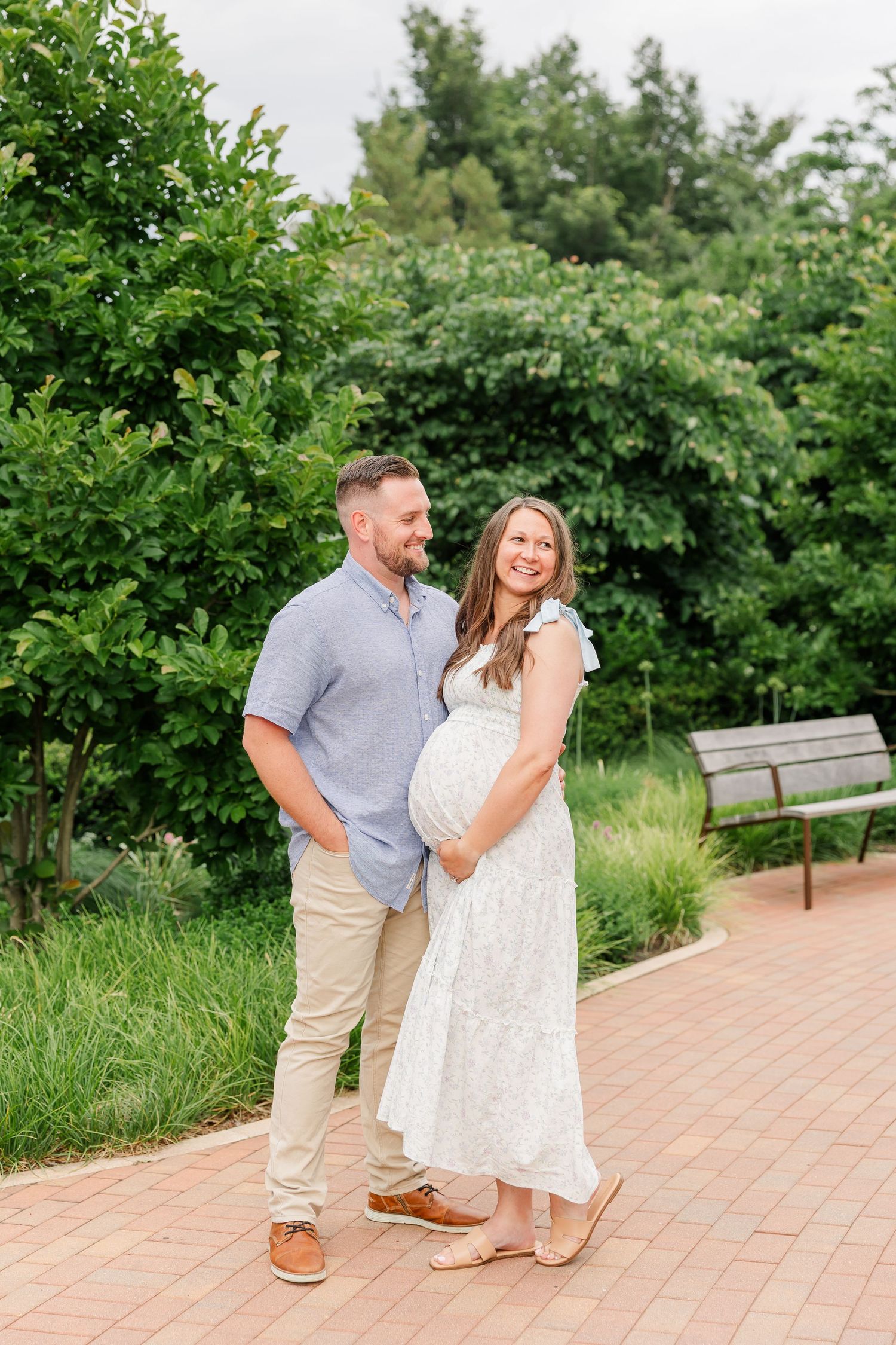Expecting parents smiling together during a Cantigny Park maternity session in Wheaton, Illinois