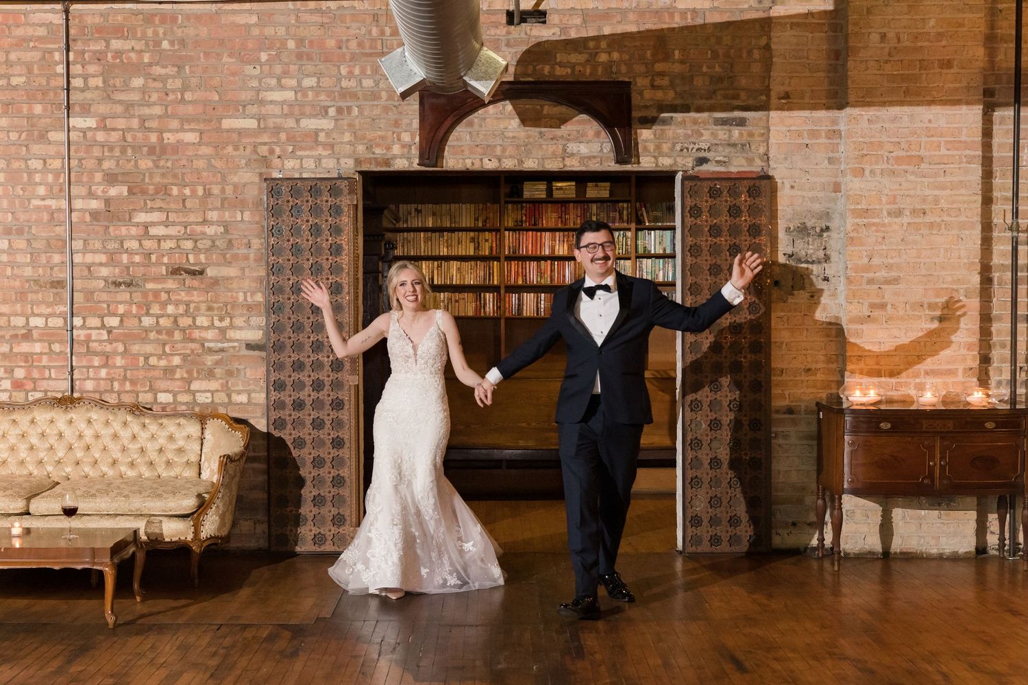 Wedding celebration in historic venue with exposed brick walls and vintage decor.