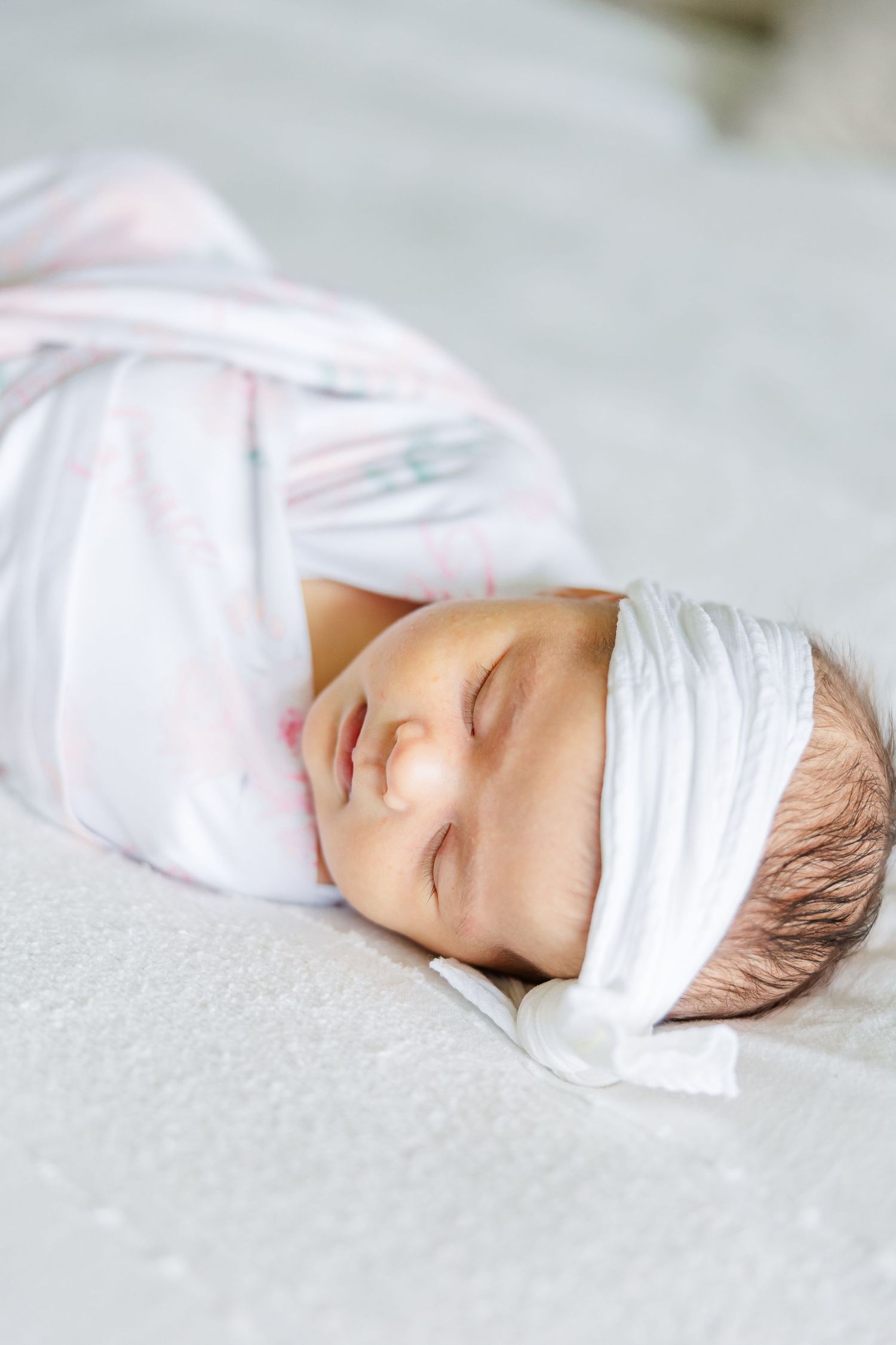 Close-up of swaddled newborn baby girl sleeping during an in-home newborn photography session