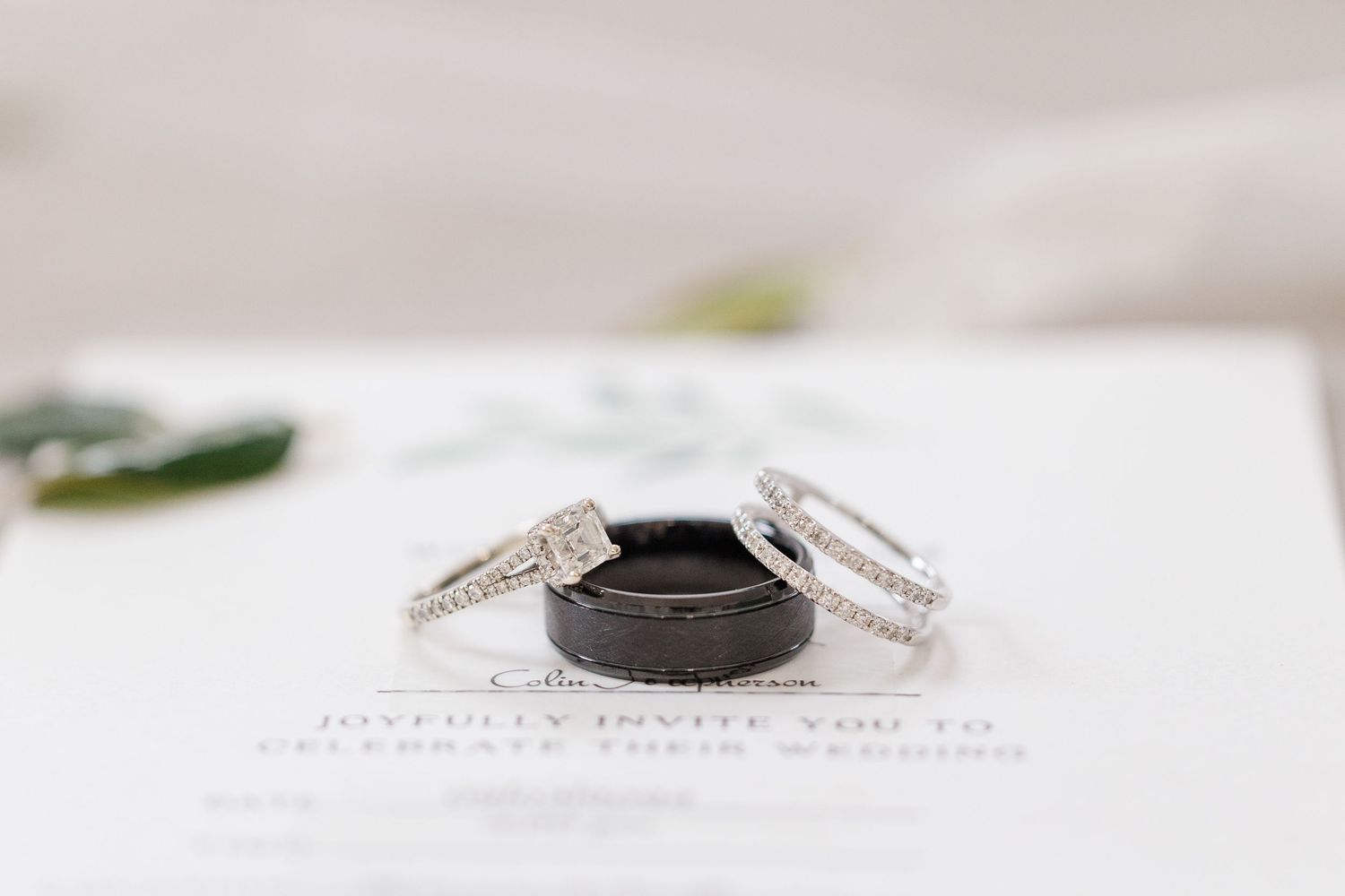 Three wedding rings arranged on a white surface with minimal styling.