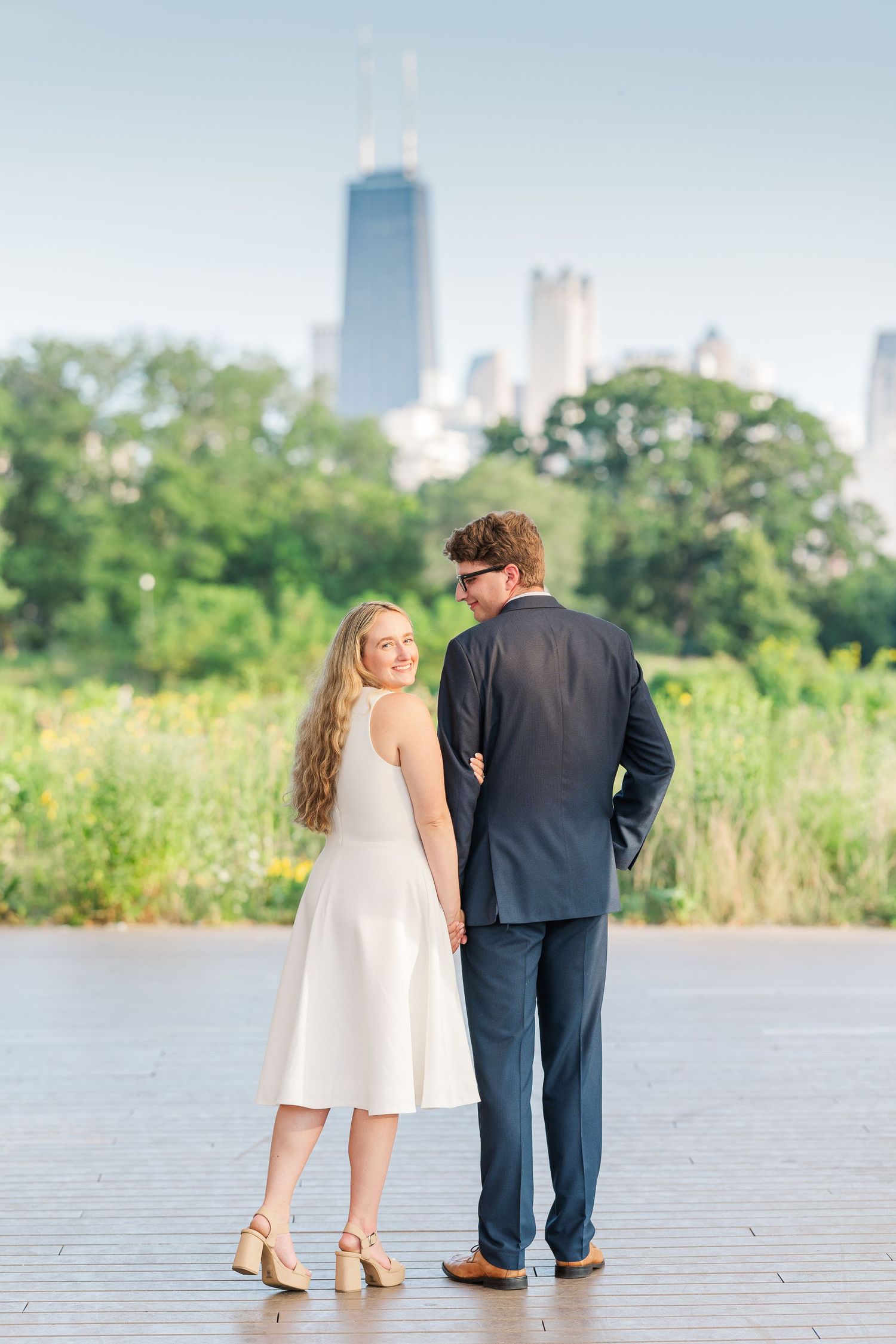 Elizabeth and Joe standing under the Honeycomb Pavilion in Lincoln Park, Chicago, smiling at the camera