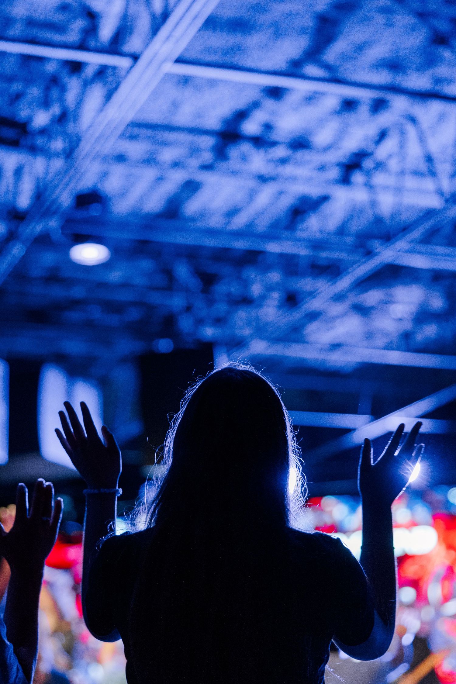 Silhouette of a woman worshipping during a service at The Chapel in McHenry
