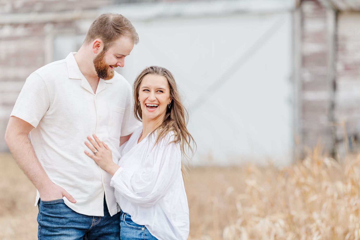 Couple smiling together during pregnancy announcement photos in Cary, Illinois