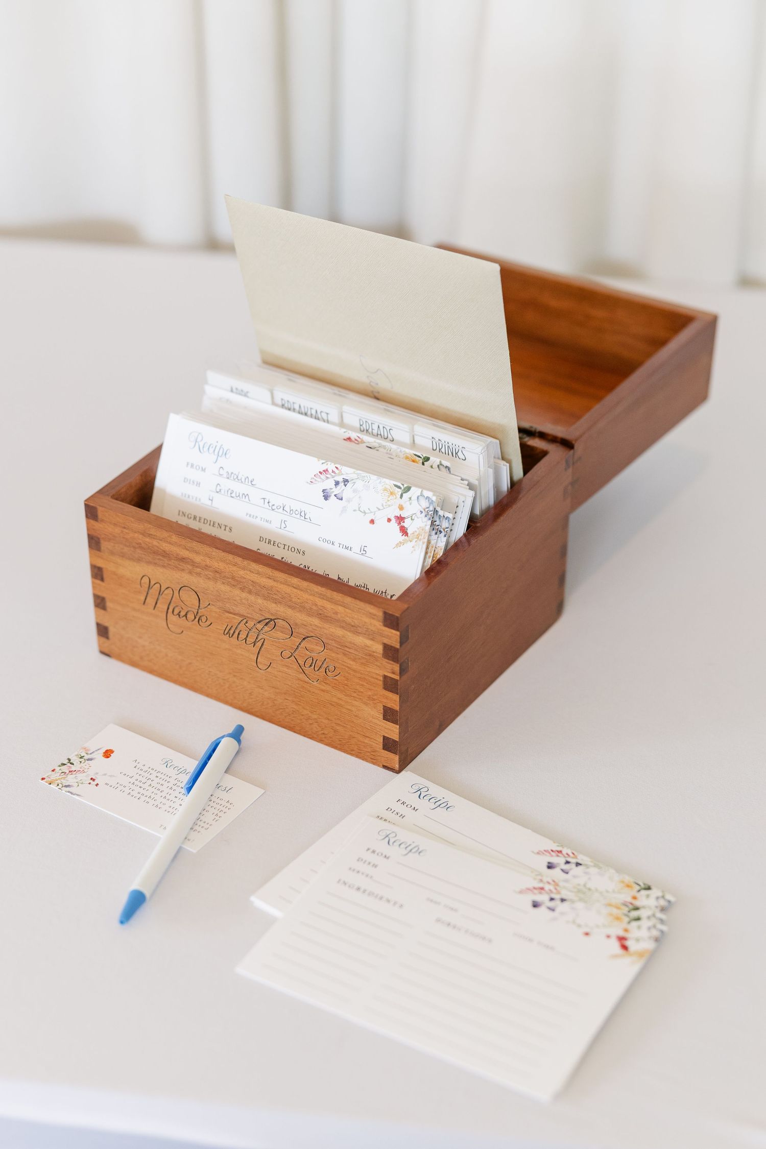 Wooden card box with wildflower cards and pen for bridal shower recipes