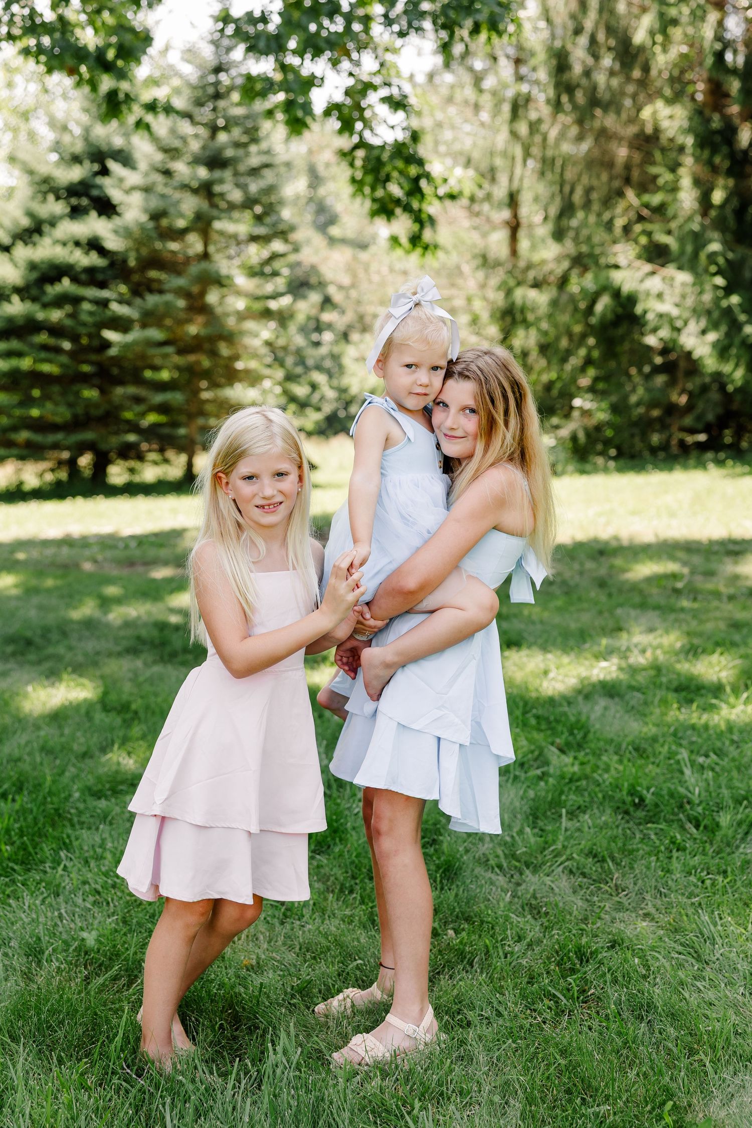 Sisters hugging during a summer family photo session in Crystal Lake, IL.
