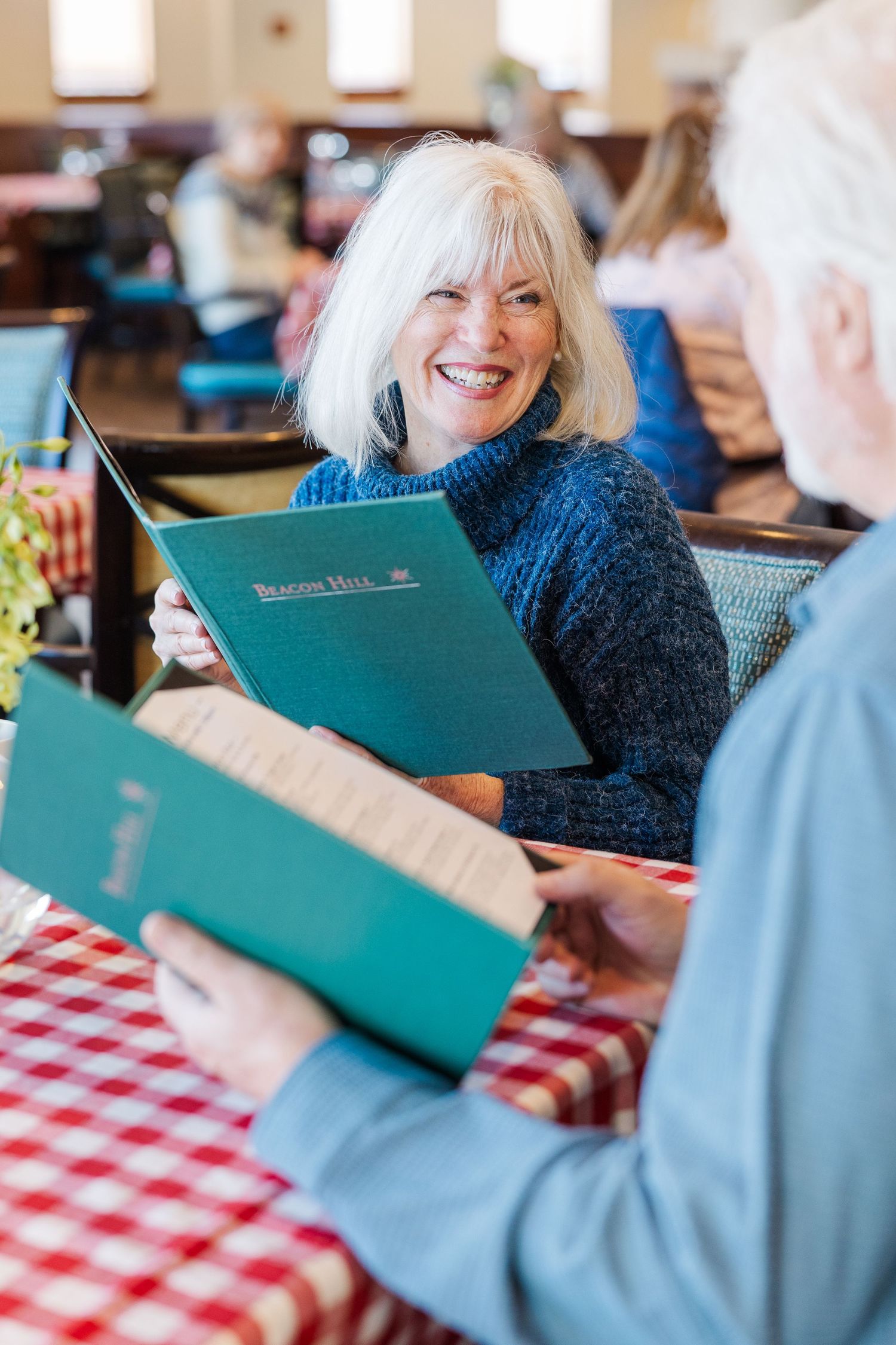 Beacon Hill senior living branding photo in Lombard, Illinois featuring residents talking over coffee