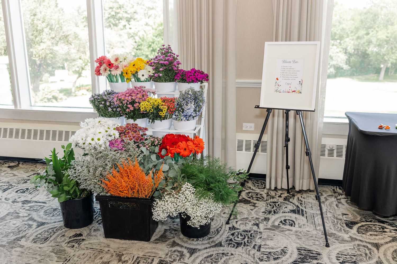 DIY bloom bar with flower buckets for guests at wildflower bridal shower