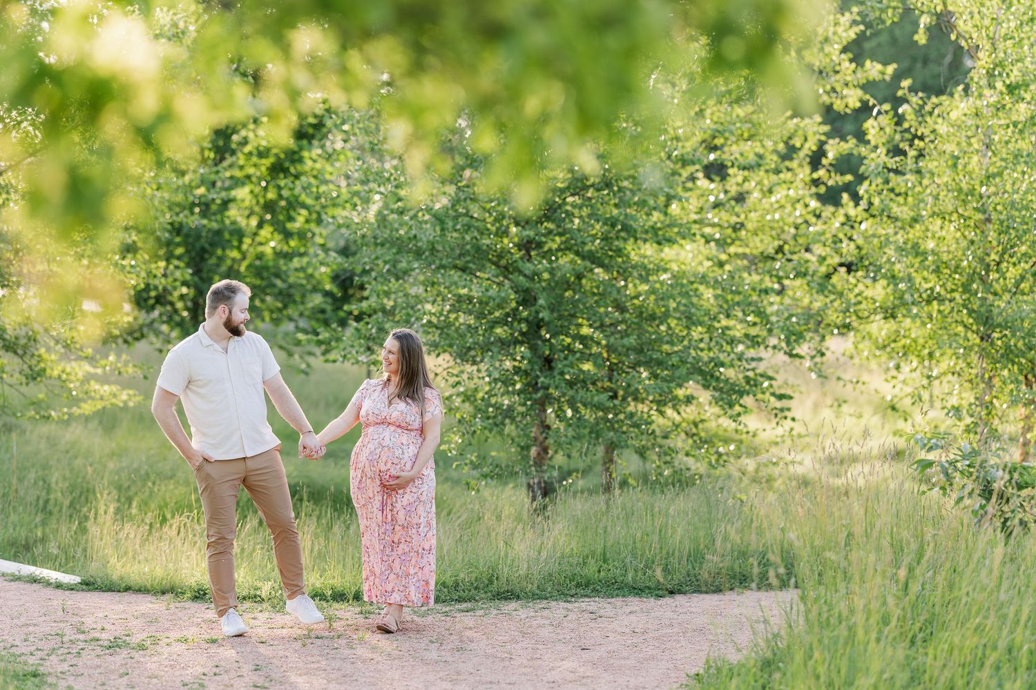 Expecting parents walking together on a garden path during their Cantigny Park maternity photos