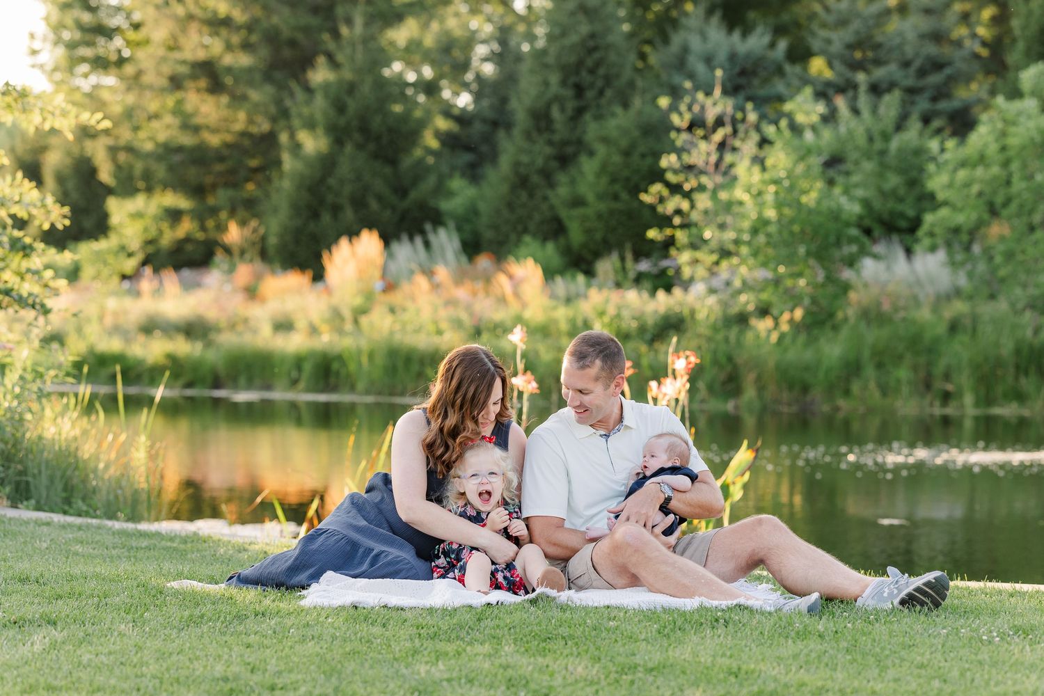 The Lawler family sharing a relaxed moment together beside the water at Cantigny Park.