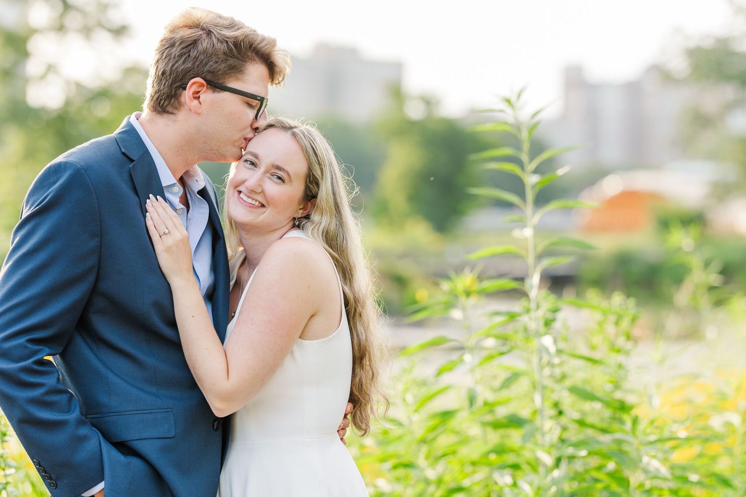 Elizabeth and Joe kissing in the wildflowers on the Lincoln Park Boardwalk in Chicago at sunset