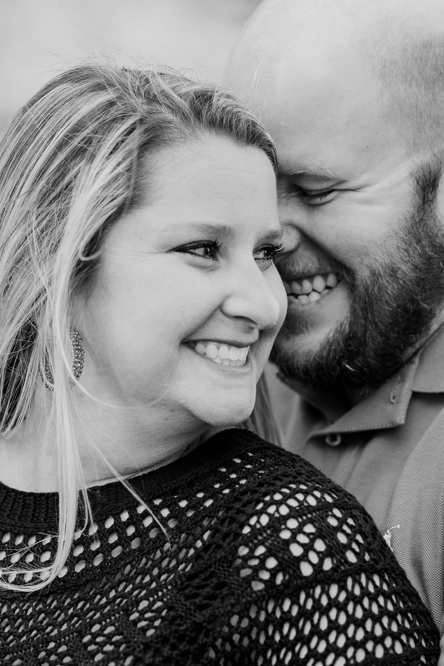 A black and white portrait of a loving couple sharing an intimate moment together.