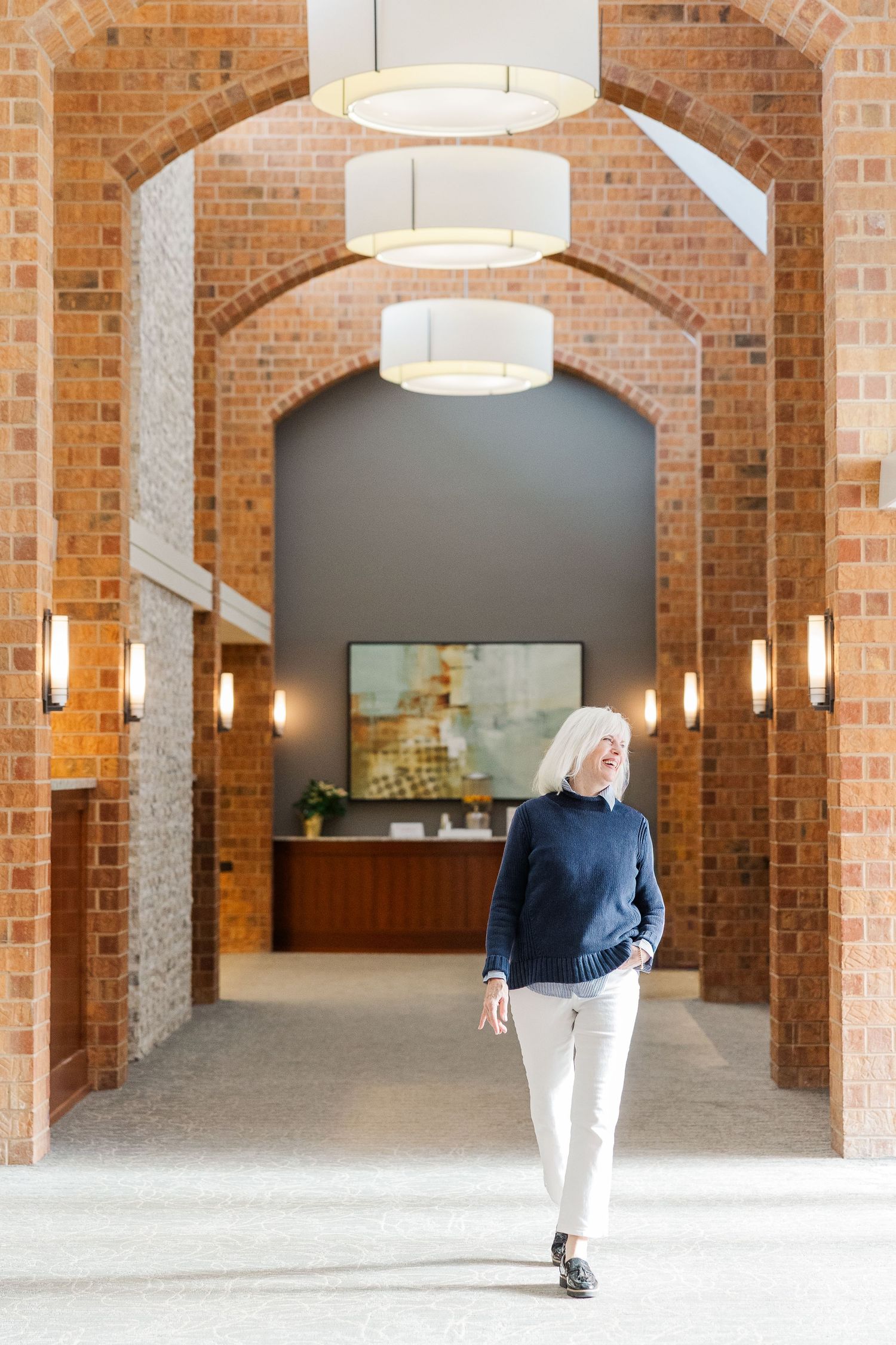 Beacon Hill senior living branding photo in Lombard, Illinois featuring resident walking through lobby
