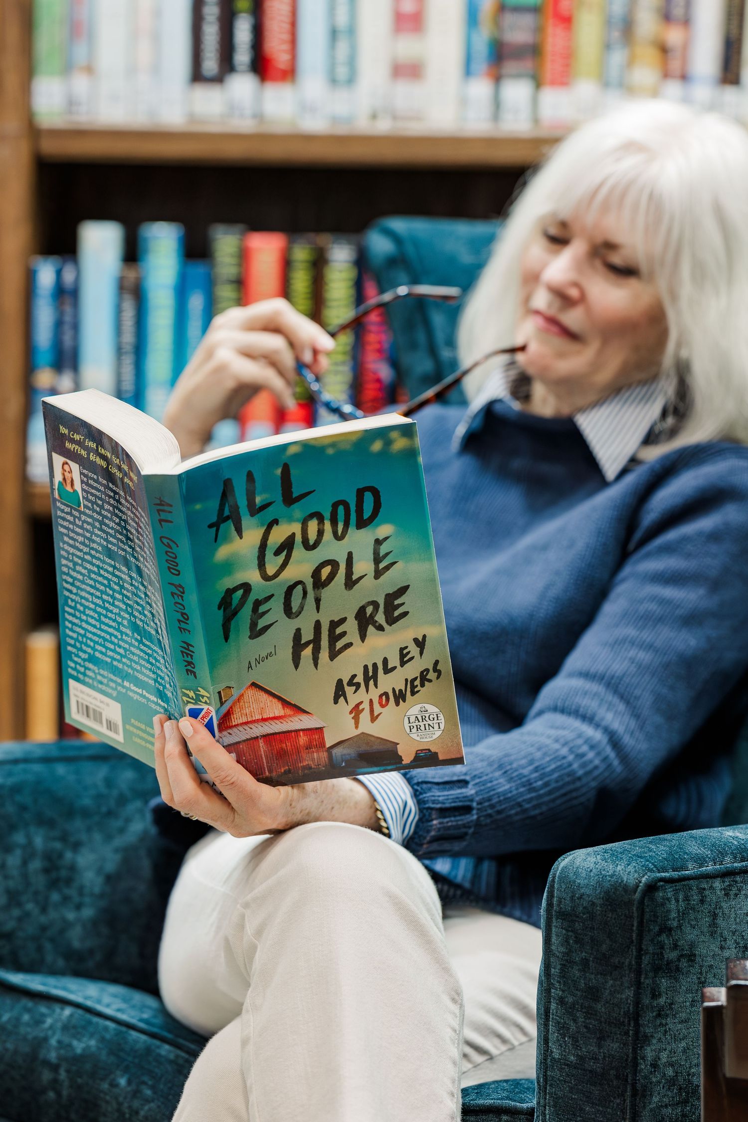 Beacon Hill senior living branding photo in Lombard, Illinois featuring resident reading novel in library