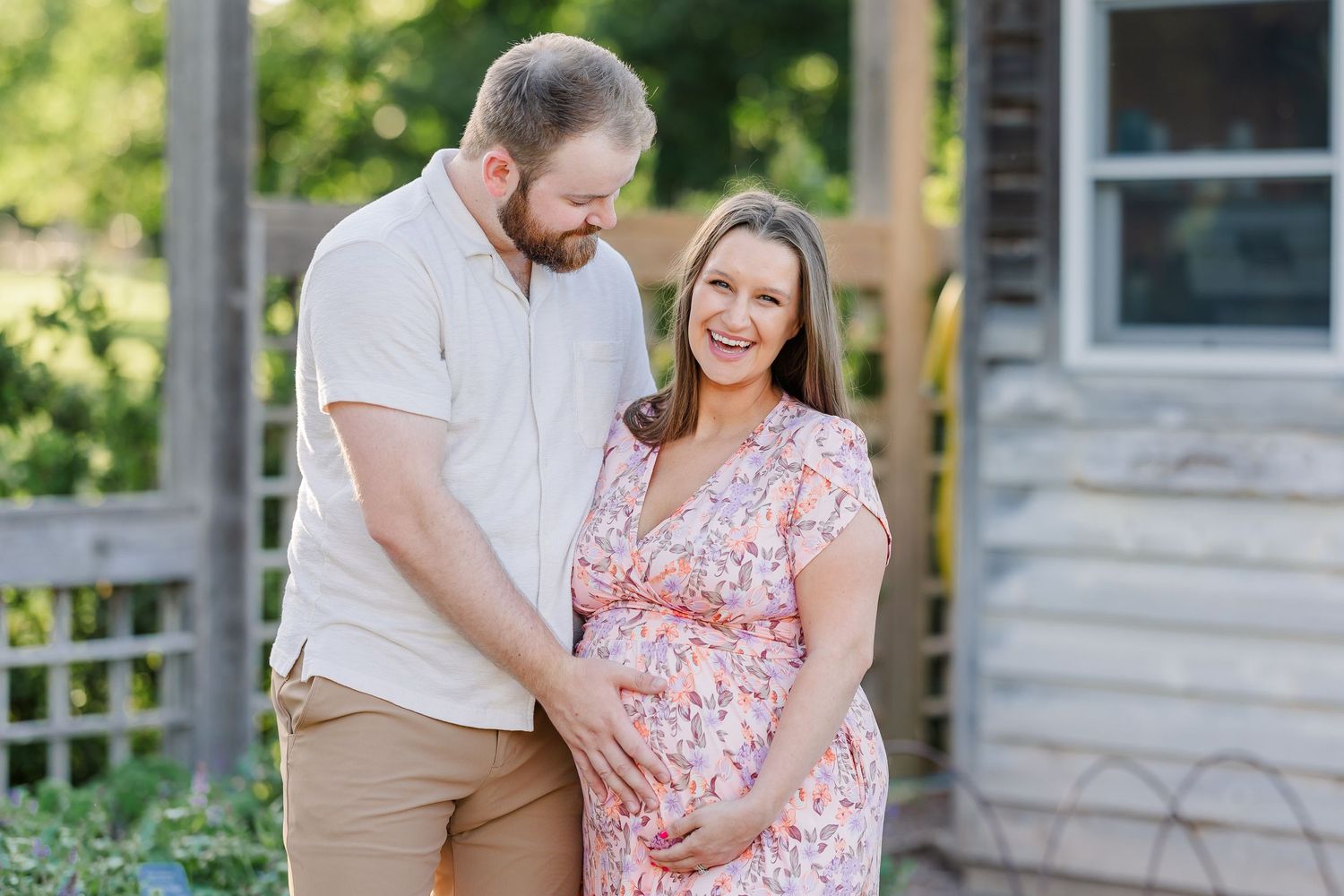 Expecting couple smiling together during a Cantigny maternity session in Wheaton Illinois summer gardens