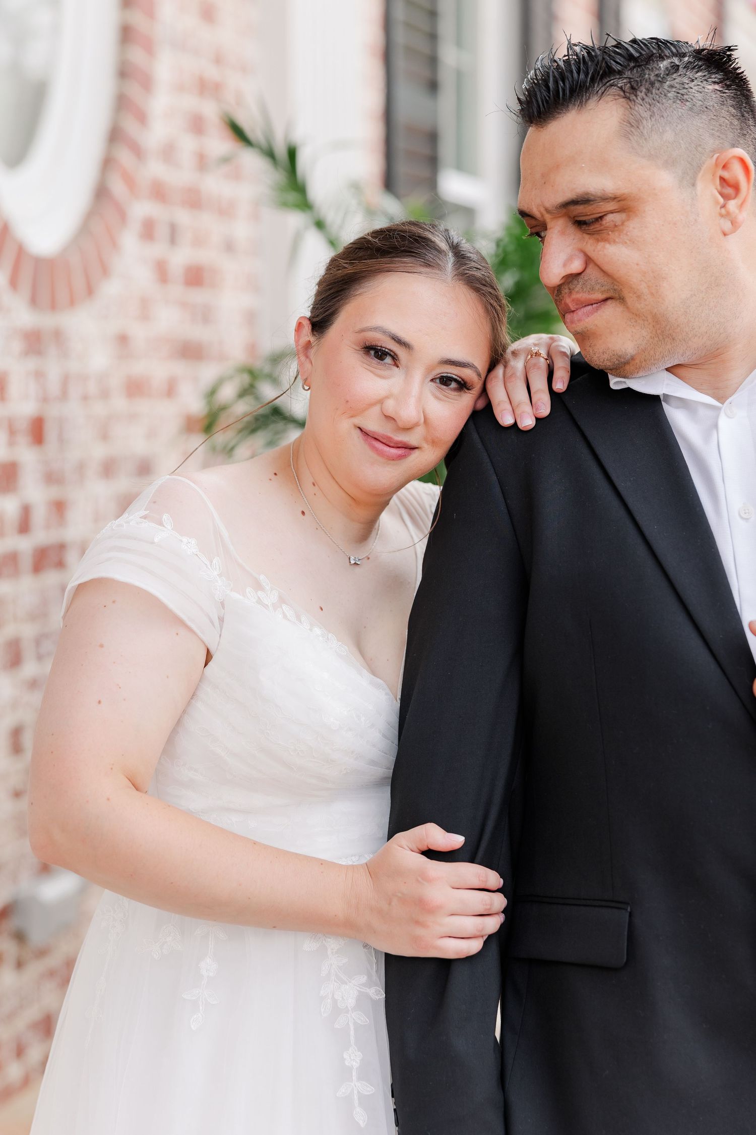Close portrait of the bride resting her head against the groom during their Cantigny Park wedding session.